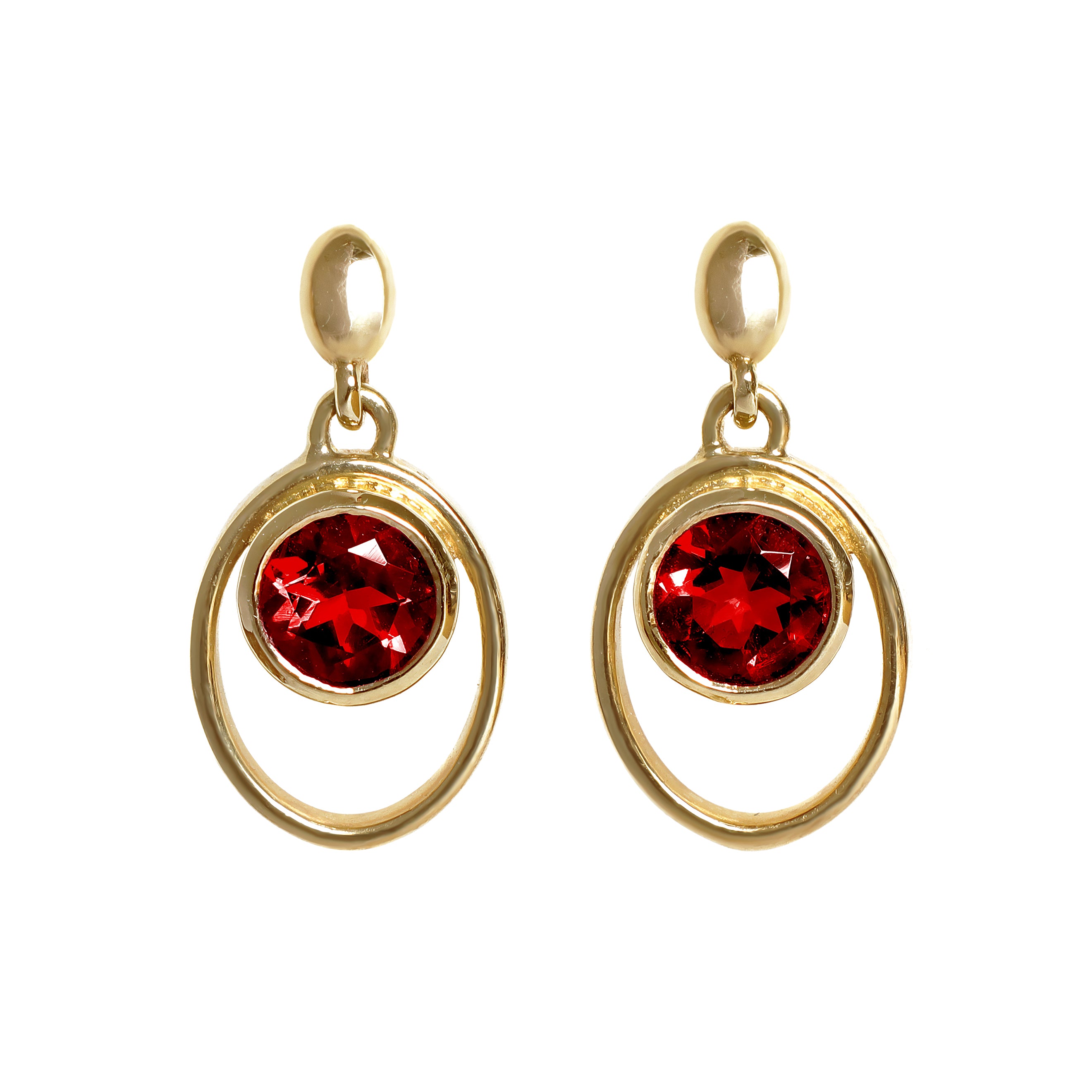 A product photo of 5.5mm Round Bezel-set Garnet Earring Studs in 9k Yellow Gold sitting on a plain white background. The bezel-set stones are nestled at the top of golden oval loops of similar thickness to the bezel frames. The garnets reflect sanguine hues across their multi-faceted edges.