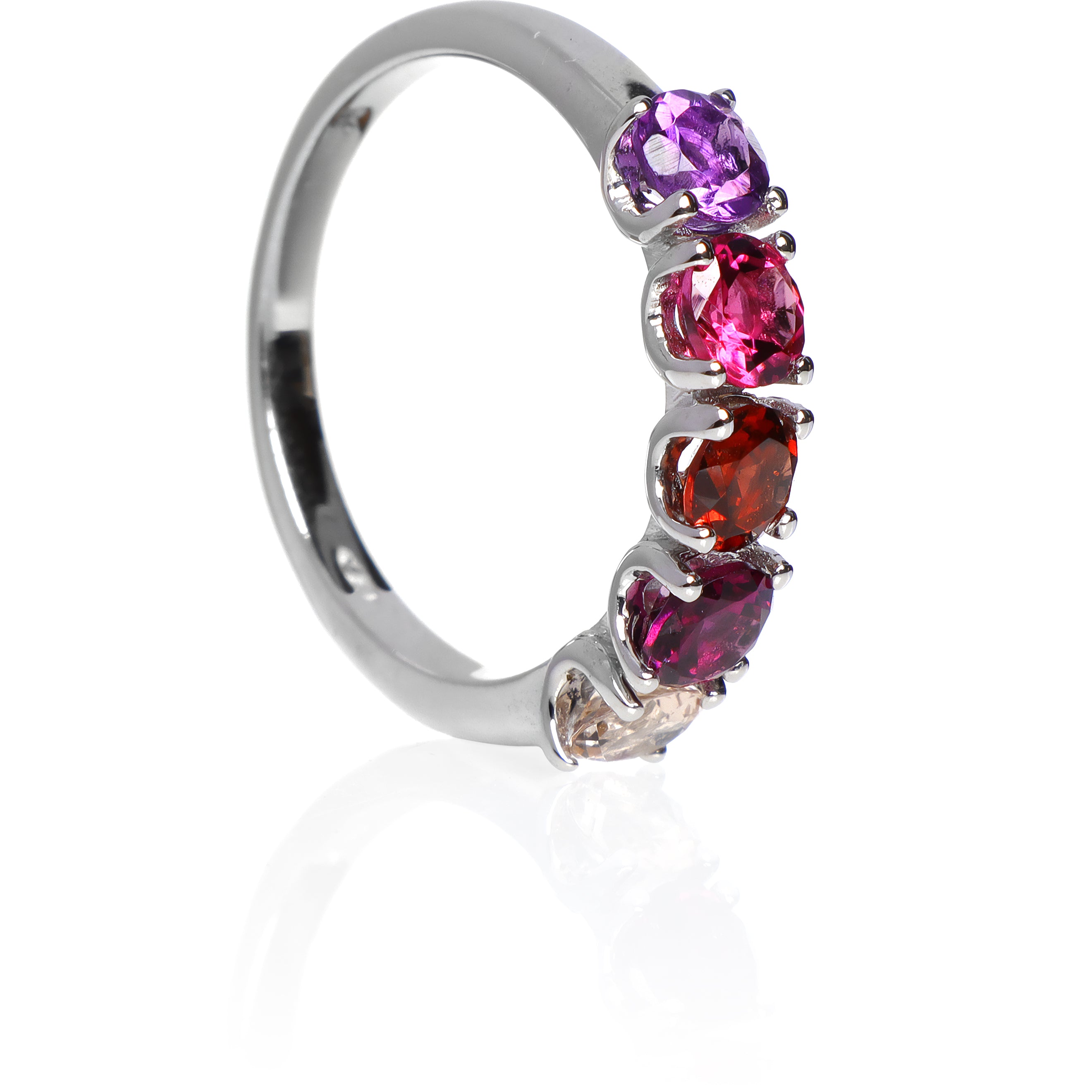 A product photo of a bold, multi-gemstone ring in 9k white gold – made up of 5 pink & red coloured jewels – sitting on a white background. From left to right, 4.5mm round-cut morganite, grape garnet, red garnet, pink tourmaline & amethyst stones make up a boldly feminine statement piece.