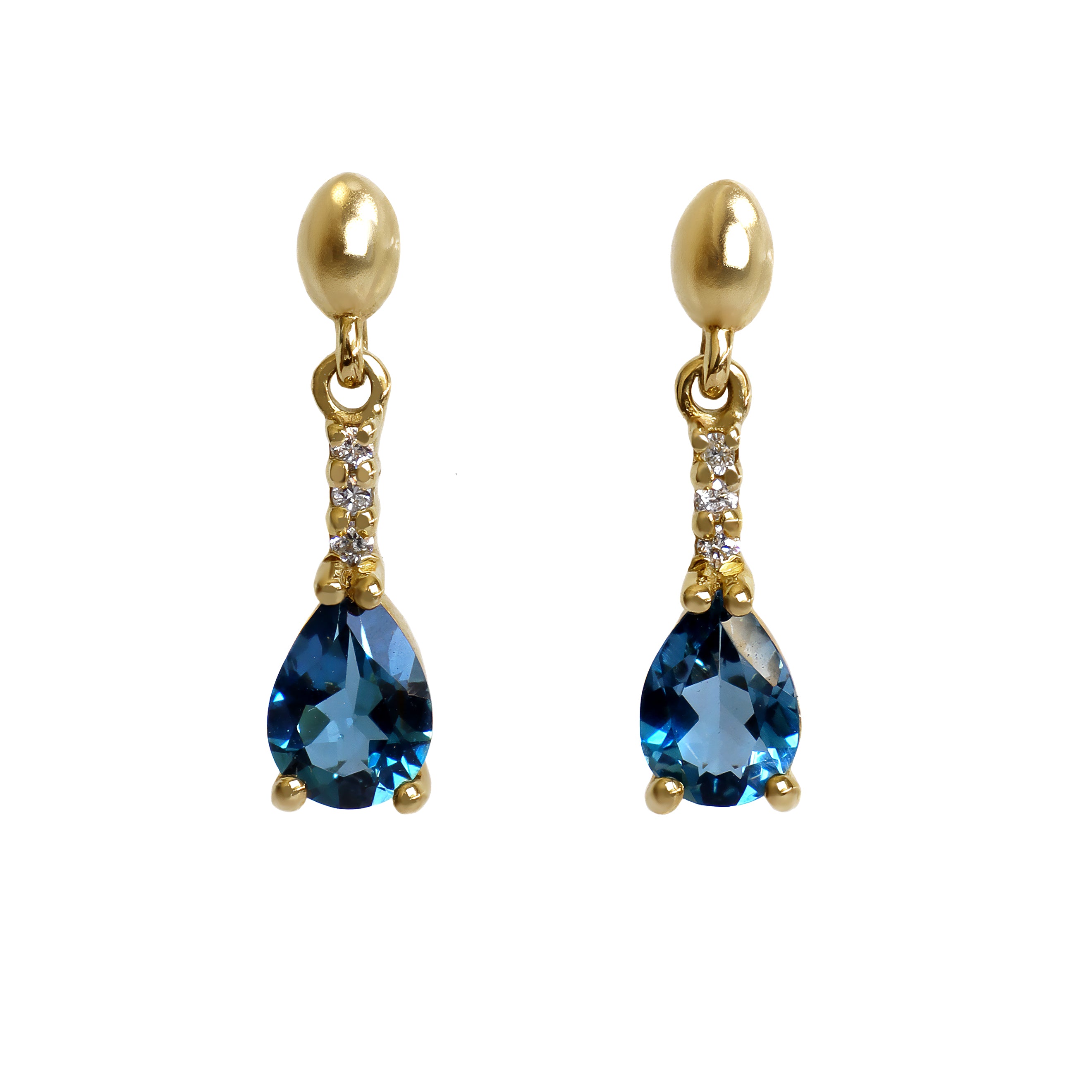 A product photo of 7x5mm Pear London Blue Topaz & Diamond Earrings in 9k Yellow Gold sitting on a plain white background. A golden strip connects the stones to the studs, each strip adorned with 3 diamonds each. The stones reflect deep, oceanic hues across their multi-faceted edges.