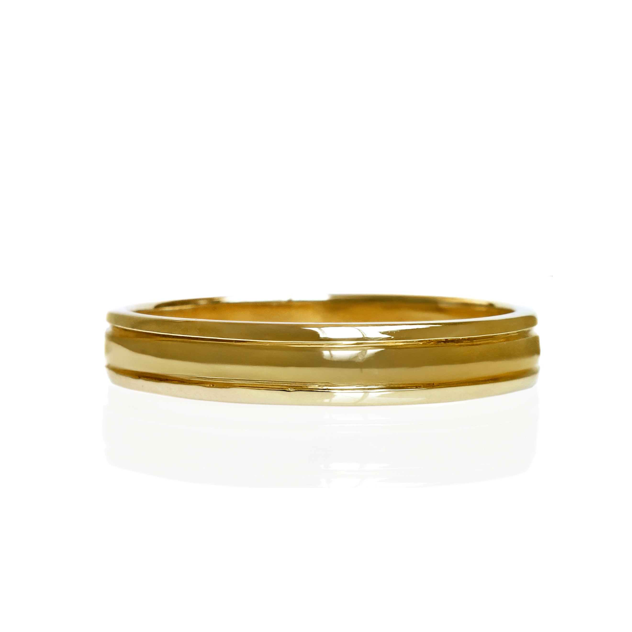 A product photo of a mens' ring made of 9k yellow gold. The band is 4mm tall and detailed with two polished grooves.