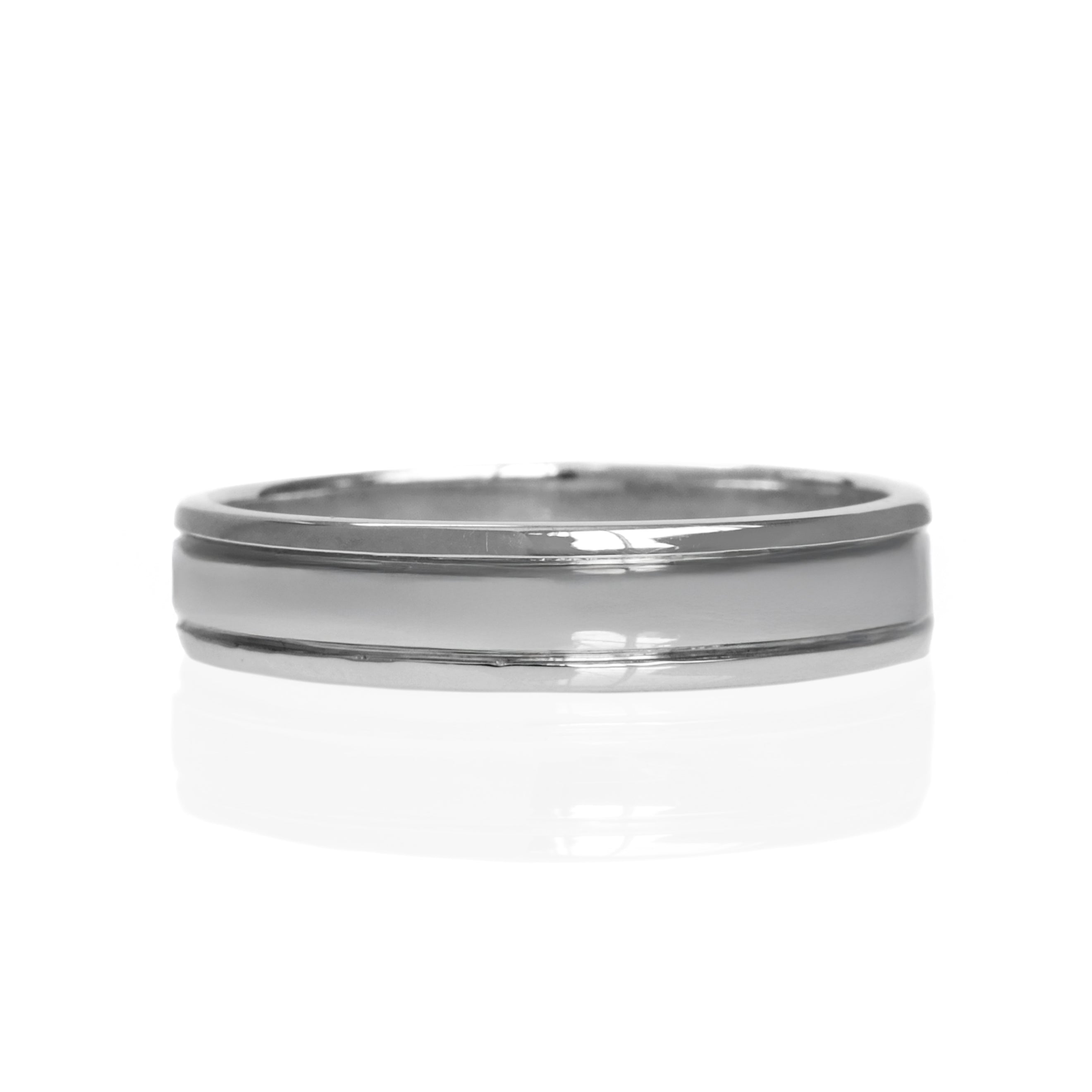 A product photo of a mens' ring made of 9k white gold. The band is 5mm tall and detailed with two polished grooves running along its length.