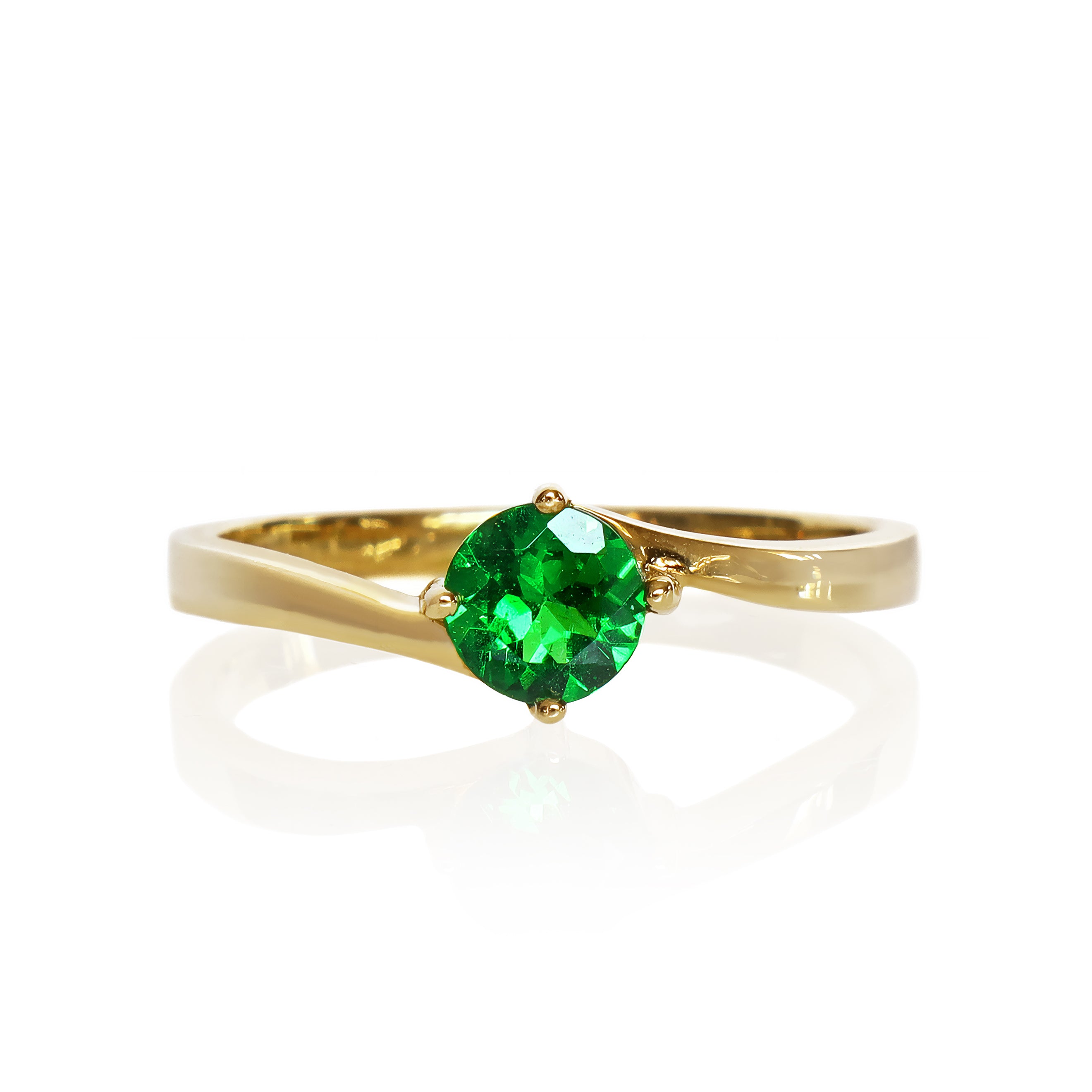 A product photo of a curved-band 9k yellow gold solitaire ring with a verdant-green tsavorite centre stone sitting on a white background. The green gemstone colour be a good emerald substitute.