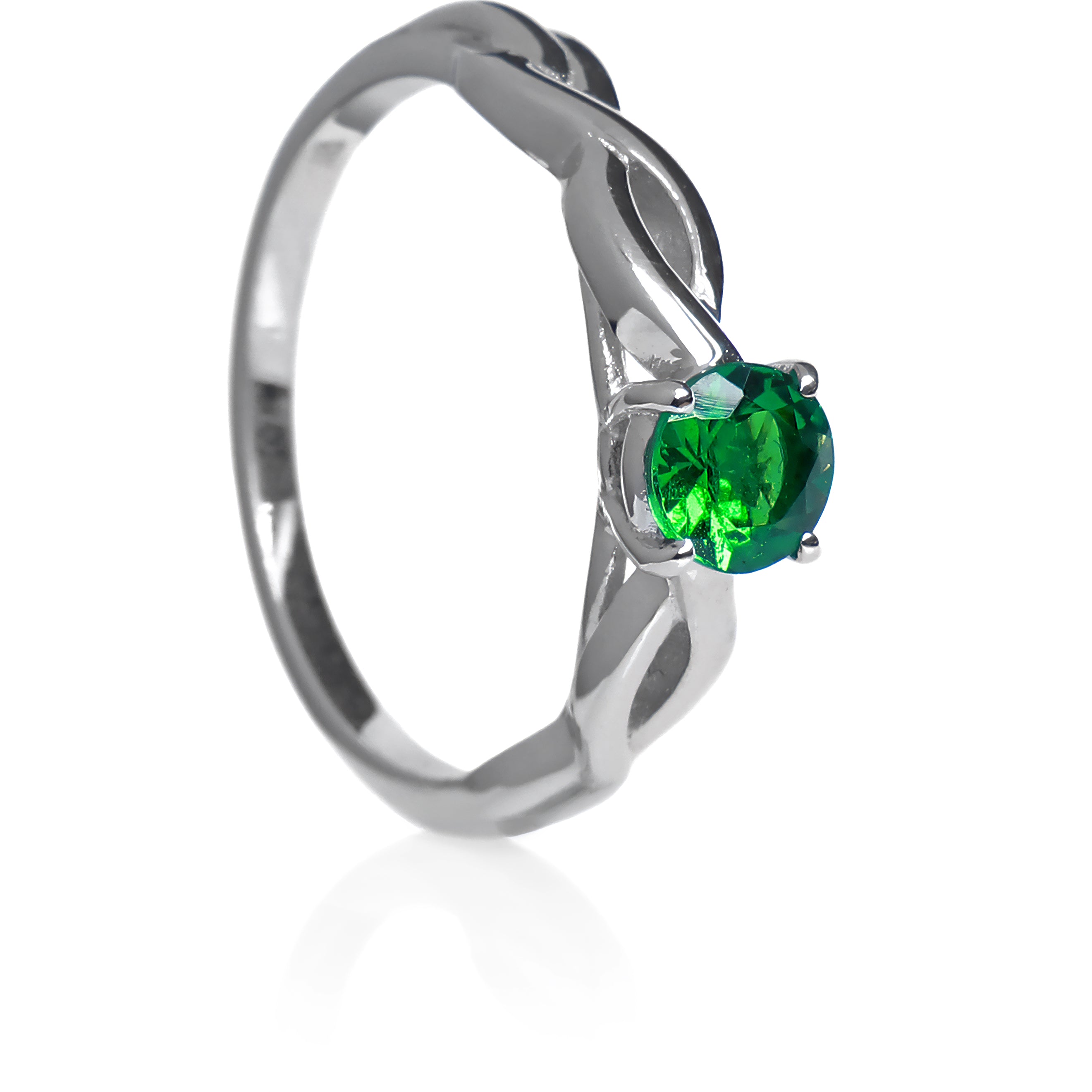 A product photo of an ornate white gold ring with a tsavorite centre stone sitting on a white background. The band splits halfway along its length, becoming twisting and serpentine in appearance before meeting on either side of the deep 5mm round tsavorite, which is held in place by 4 silver claws. The green gemstone colour would be a good emerald substitute.
