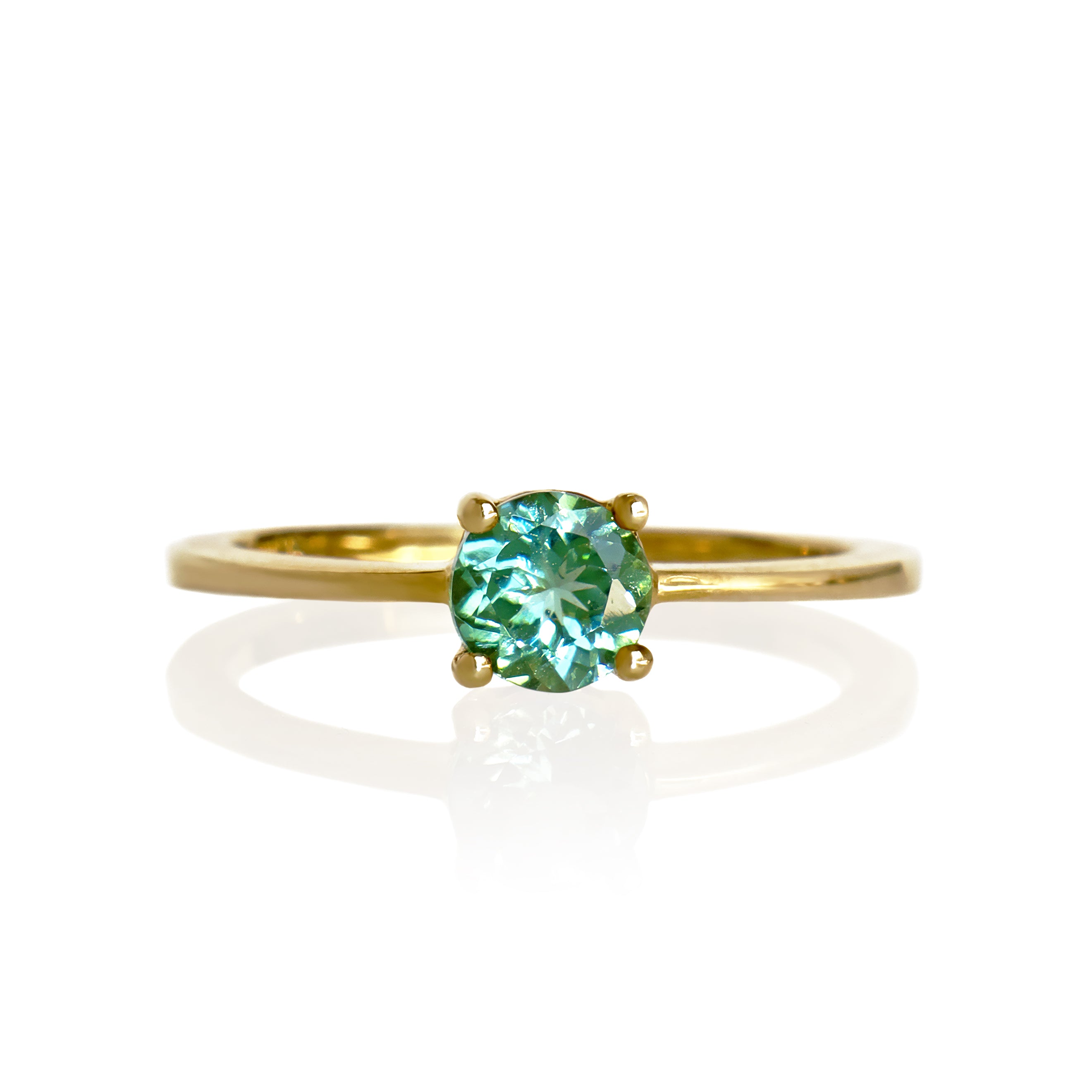 A product photo of a simple 9k yellow gold solitaire ring with a mint green tourmaline centre stone sitting on a white background. The green gemstone colour be a good emerald substitute.