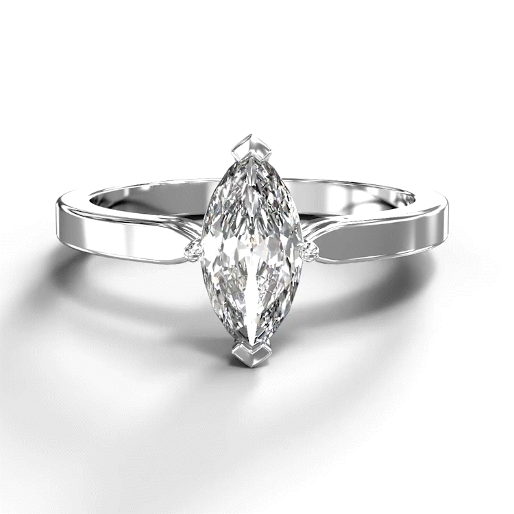 A turntable video of a 14 karat white gold lab diamond solitaire engagement ring sitting in the sun on a white textured background. The brilliant, colourless 0.70ct marquise diamond measures about 8.5mm lengthwise, and is held in place by 4 delicate claws in a low-profile prong setting in the middle of a sharply tapered band.