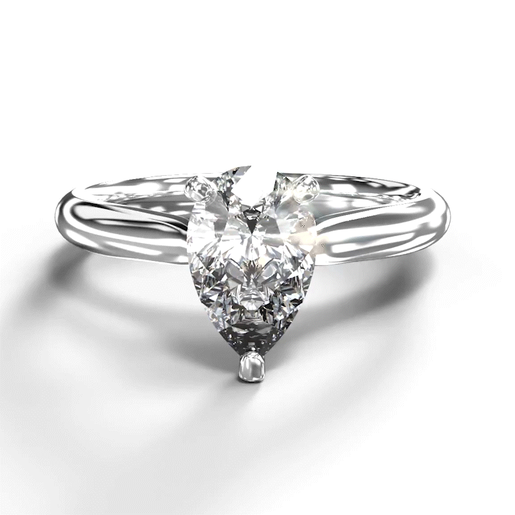 A turntable video of a 14 karat white gold lab diamond solitaire engagement ring sitting in the sun on a white textured background. The brilliant, colourless 1 carat pear-cut diamond measures 8.73mm lengthwise, and is held in place by 3 delicate claws in a high-profile cathedral setting in the middle of a tapered band.