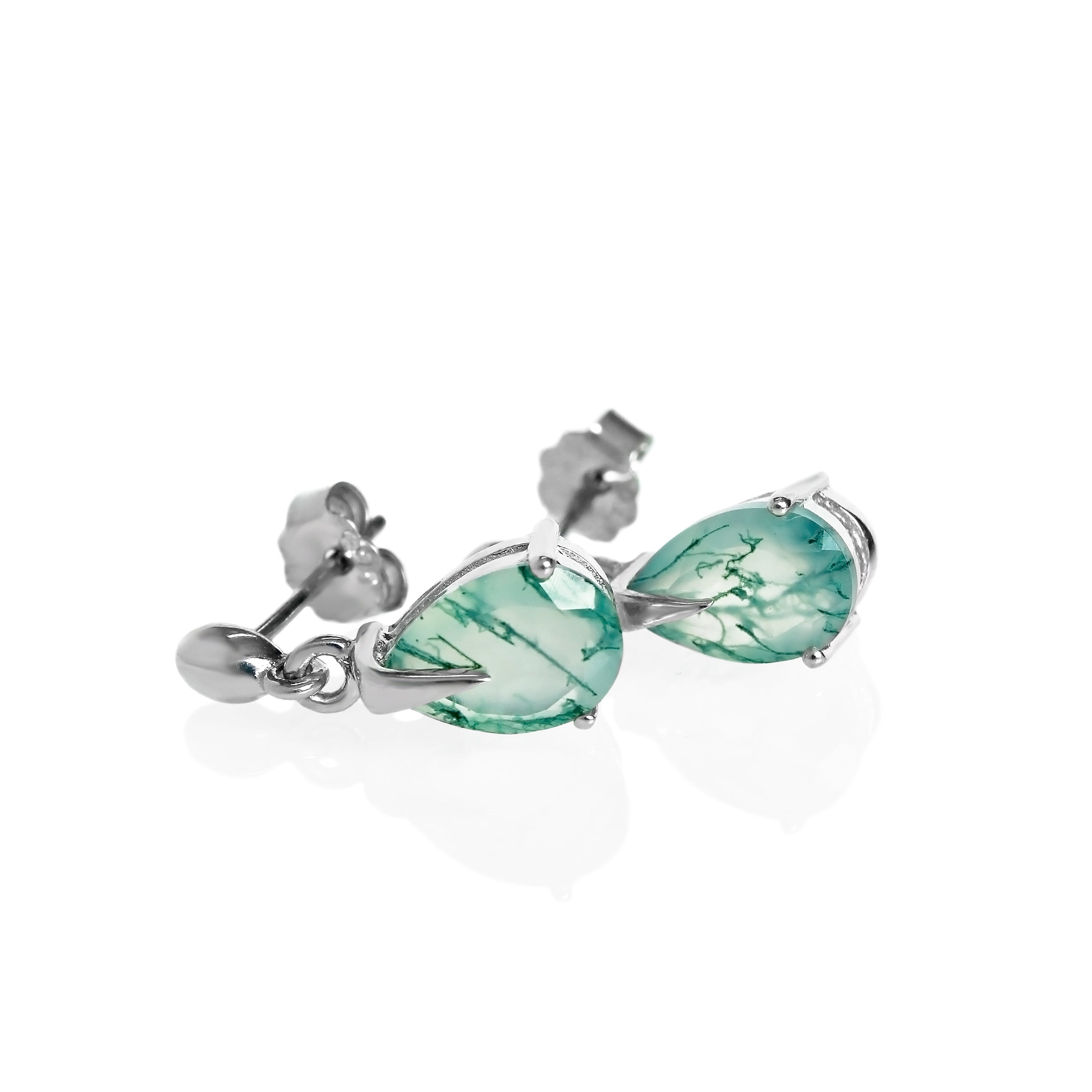 A product photo of a pair of 9x7mm pear-shaped moss agate drop earrings in 925 sterling silver on a white background. The gemstones have a cool white milky colour, with deep, swirling green natural inclusions, and are each held in place with a singular sharp prong, giving them a severe yet elegant appearance.