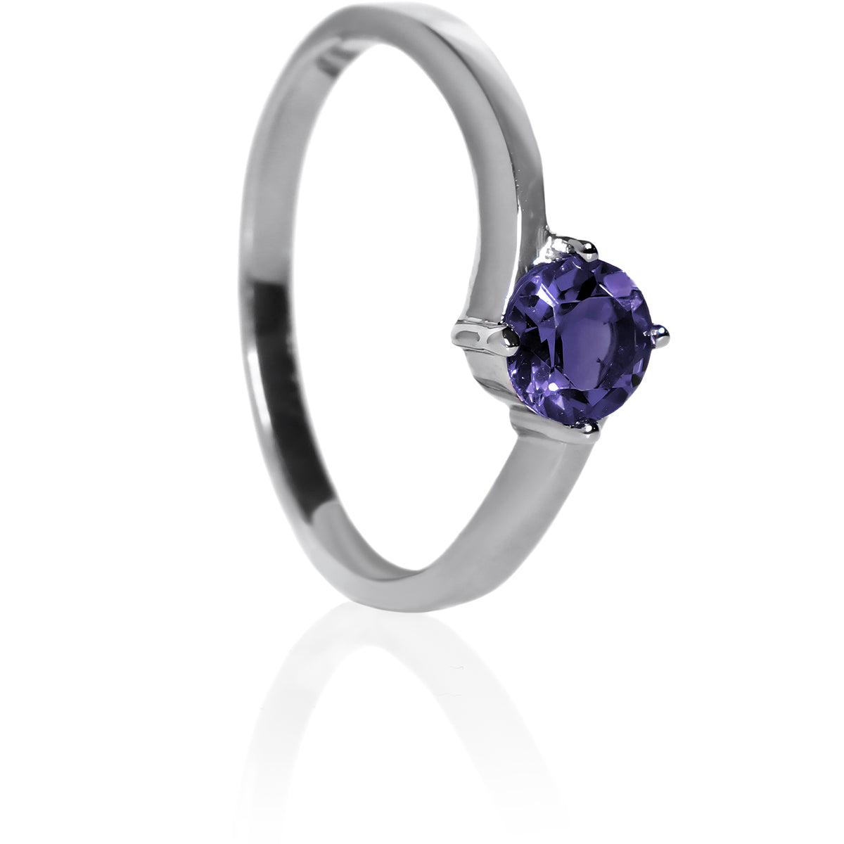 A product photo of a curved-band silver solitaire ring with a midnight blue iolite centre stone sitting on a white background. The deep blue gemstone colour would be a good sapphire substitute.
