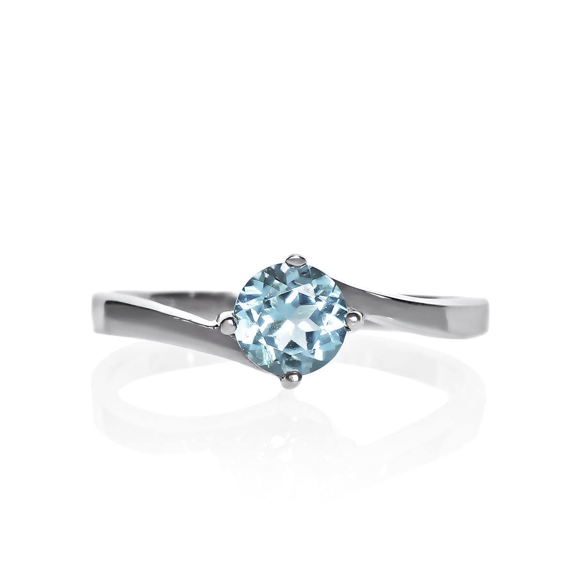 A product photo of a curved-band silver solitaire ring with a pale blue aquamarine centre stone sitting on a white background.
