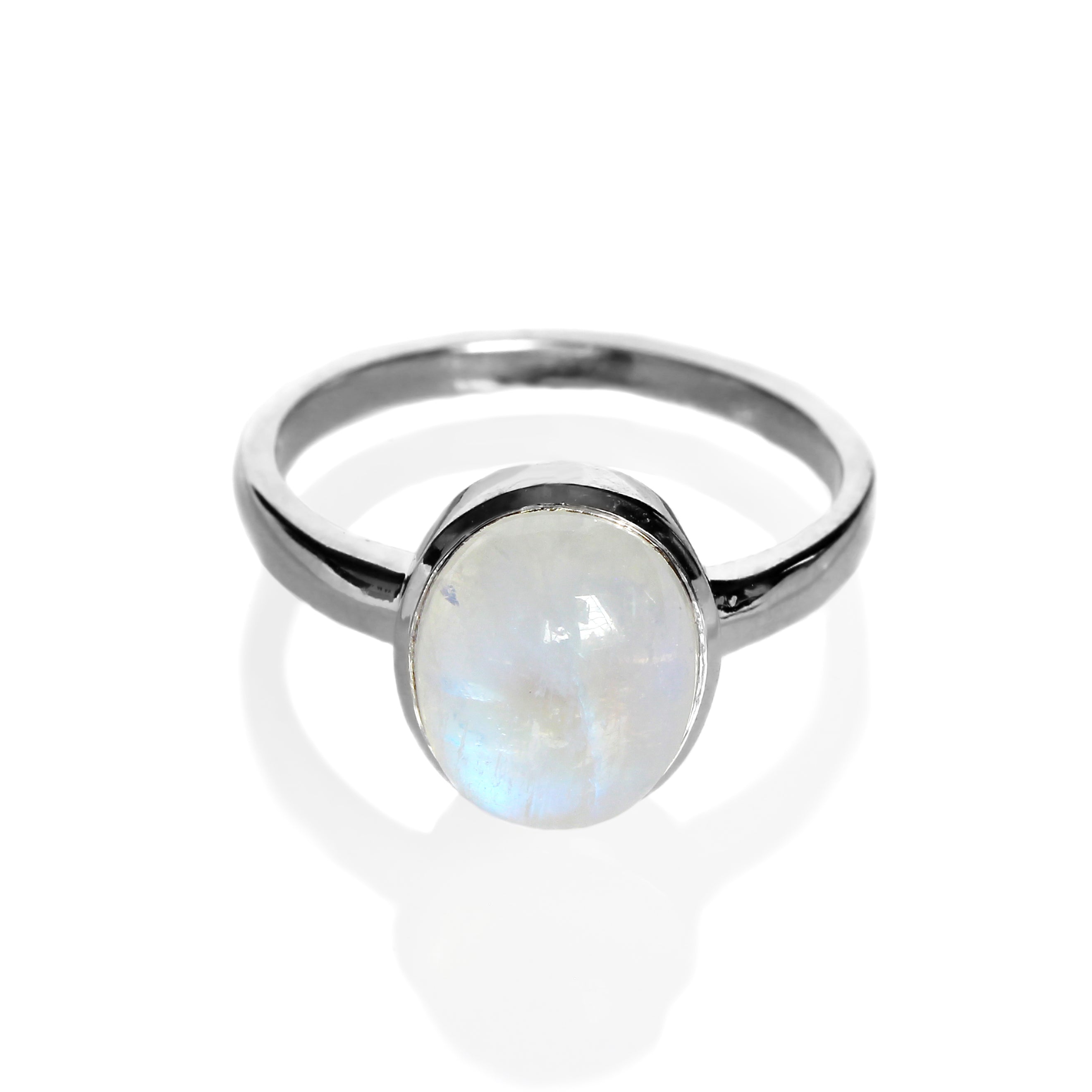 A product photo of a silver moonstone ring on a white background. The band is tall and thick. The 10x8mm oval cabochon opal stone is uniquely translucent, with a blue-hued sheen. The stone is set in a thick silver bezel setting.