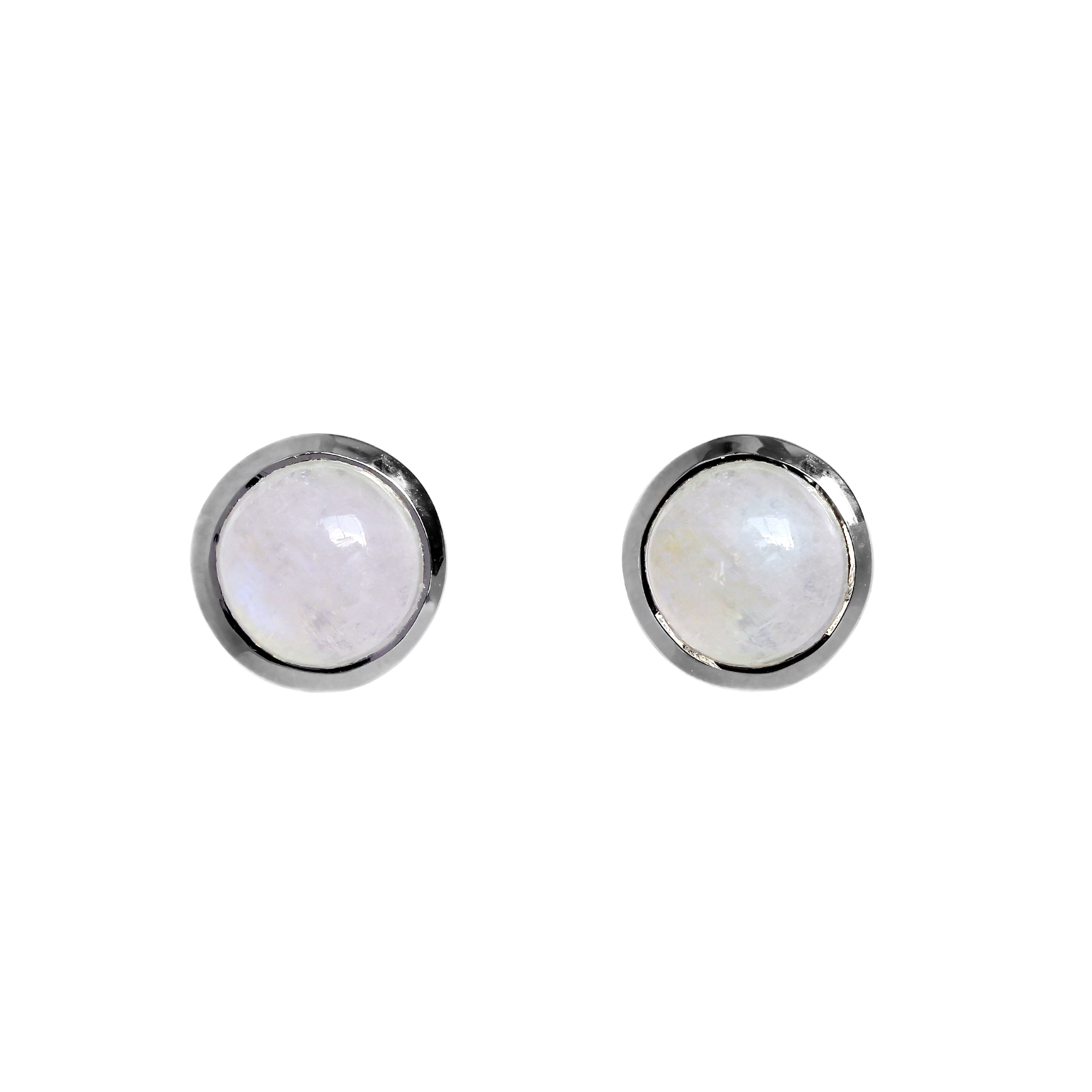 A product photo of a pair of silver moonstone stud earrings sitting against a white background. The 10mm round gemstones have a grey and blue sheen and unique milky inclusions, and are secured in place in bezel settings.