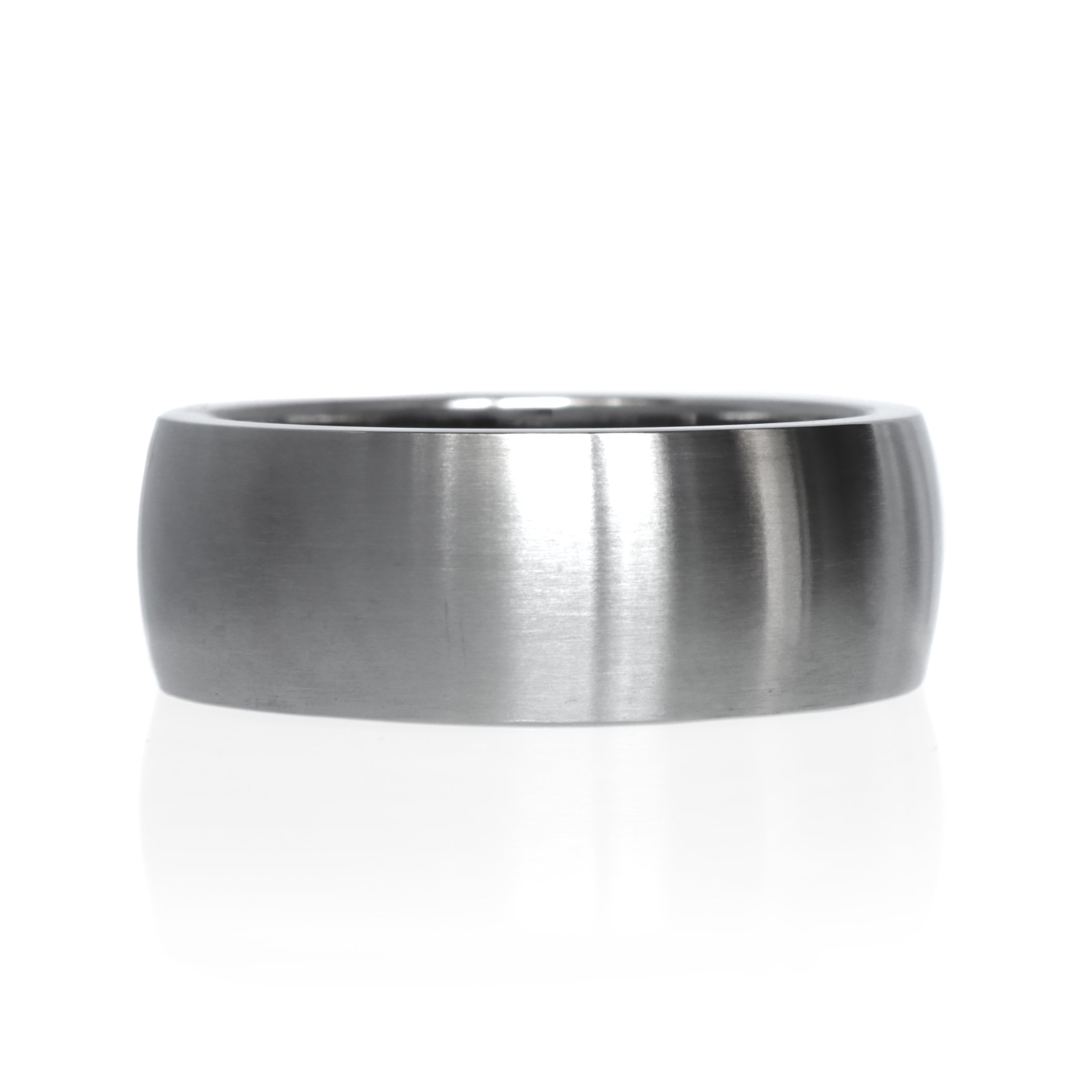 A product image of a 9mm wide ring against a plain white background. The ring is crafted from titanium with a uniform brushed finish across its surface. The brushed texture gives the ring a subtle matte appearance, while the smooth, rounded edges add a touch of softness.