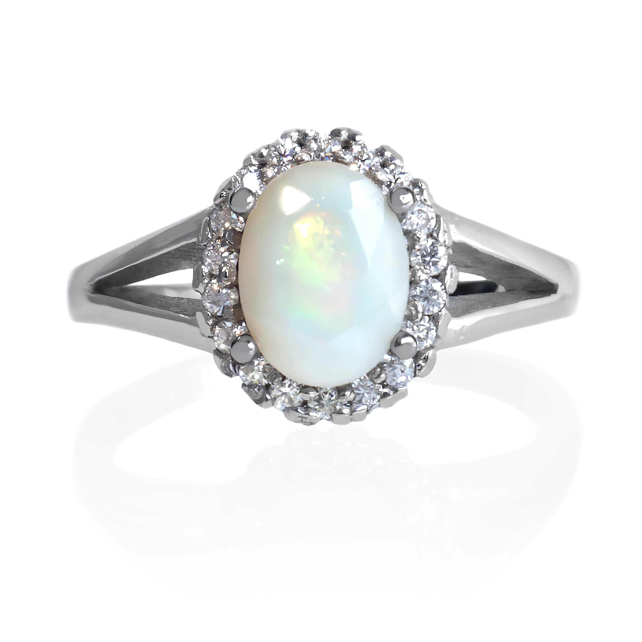 A product photo of a lavish moissanite halo opal ring in solid sterling silver on a white background. The smooth band splits in two halfway along its length on either side, meeting the halo and Ethiopian opal in the centre. The impressively large rainbow opal stone is held in place by 4 claws.