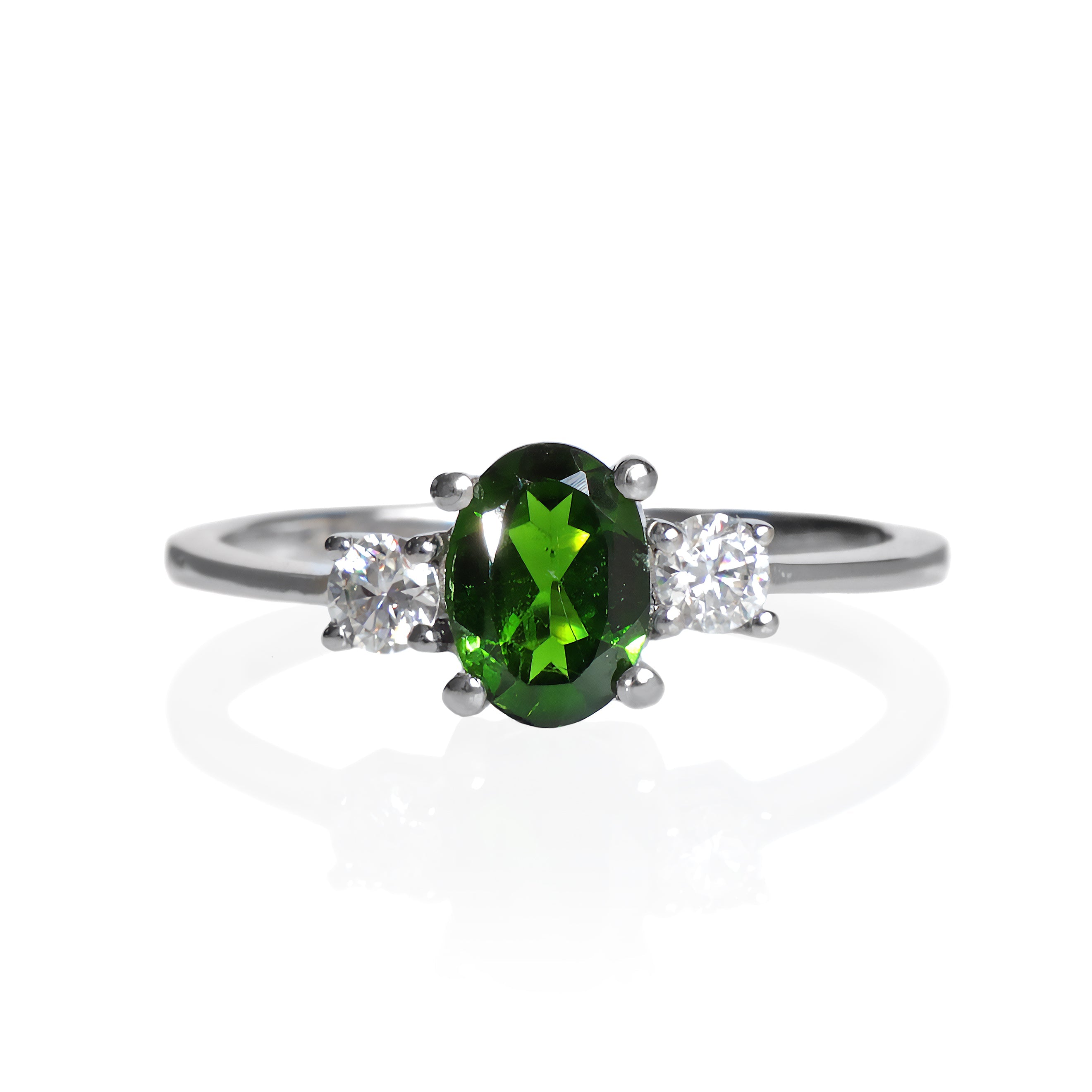 A product photo of a faceted chrome diopside and moissanite ring in solid sterling silver on a white background. The chrome diopside sparkles vibrant electric green, while the round faceted moissanites add a burst of sparkling rainbow fire to the ring.
