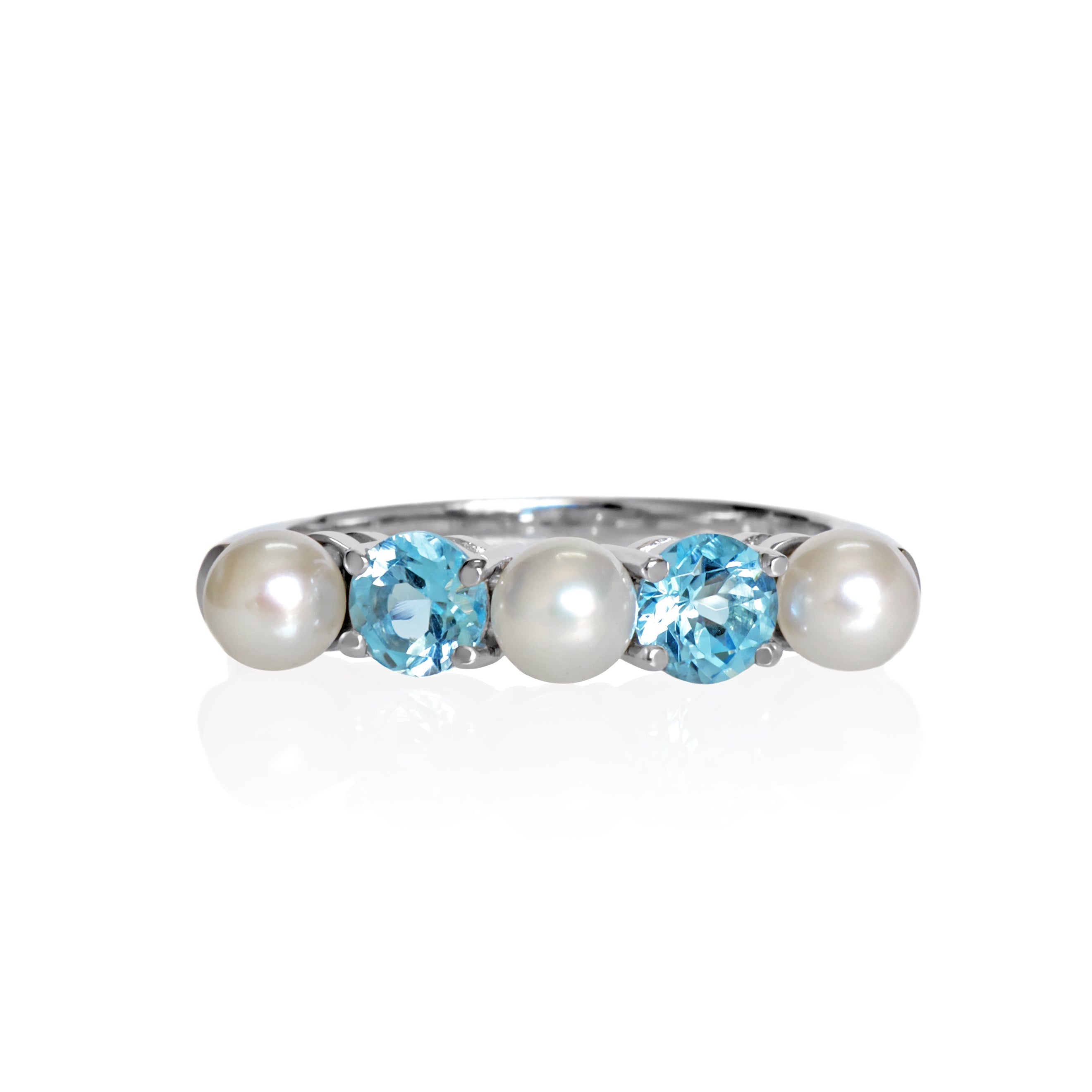This product image shows a white pearl and blue topaz eternity ring set in solid 9 karat white gold. The ring is made up of 3 round creamy white pearls of 4.5mm in diameter, two on the outer edges of the eternity design and one in the centre. Between each pearl sits an vibrant sky blue round-cut topaz jewel of similar sizing.