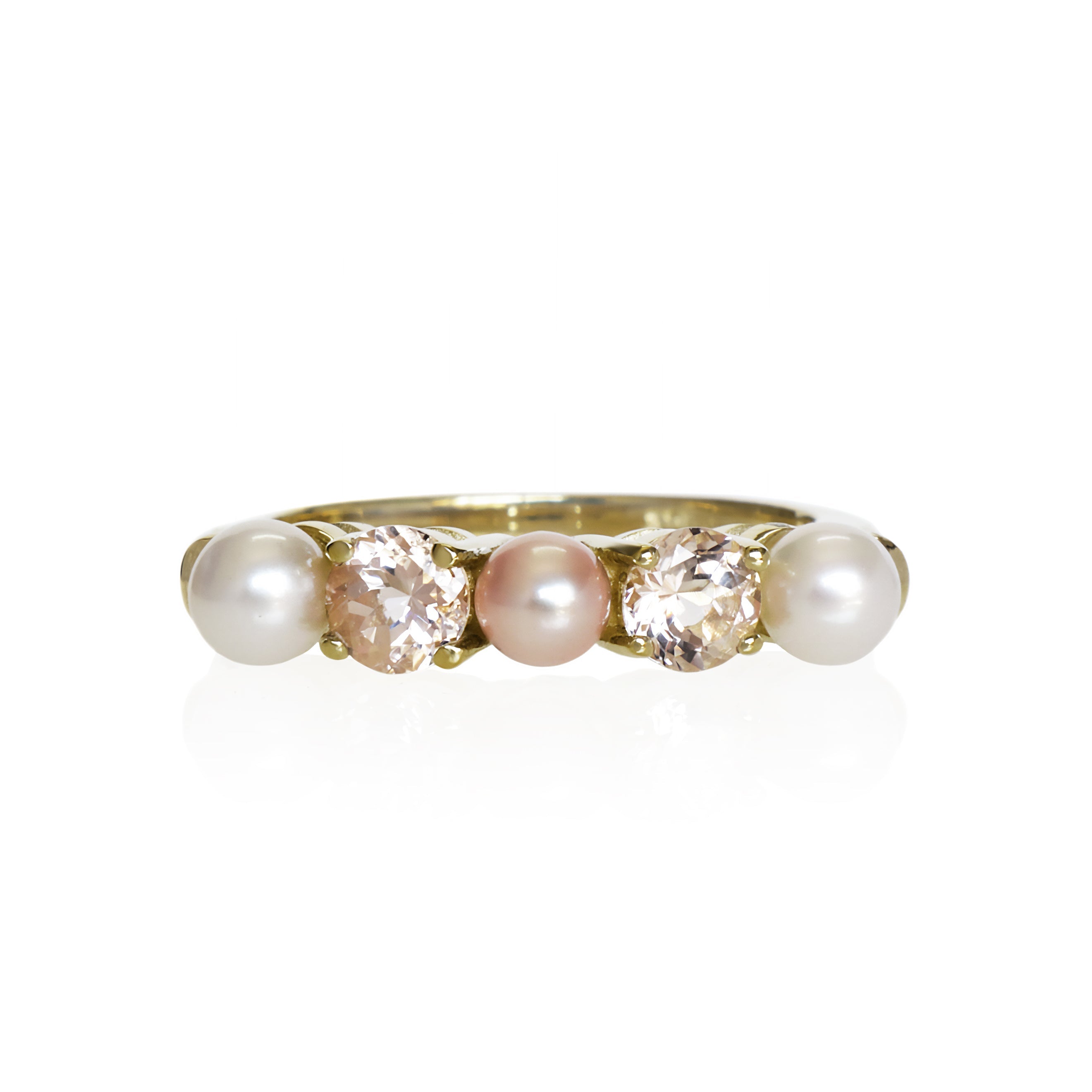 This product image shows a rosaline and white pearl morganite eternity ring set in solid 9 karat yellow gold. The ring is made up of 3 round freshwater pearls of 4.5mm in diameter, two creamy white pearls on the outer edges of the eternity design and one rosaline one in the centre. Between each pearl sits a baby pink round-cut morganite jewel of similar sizing.