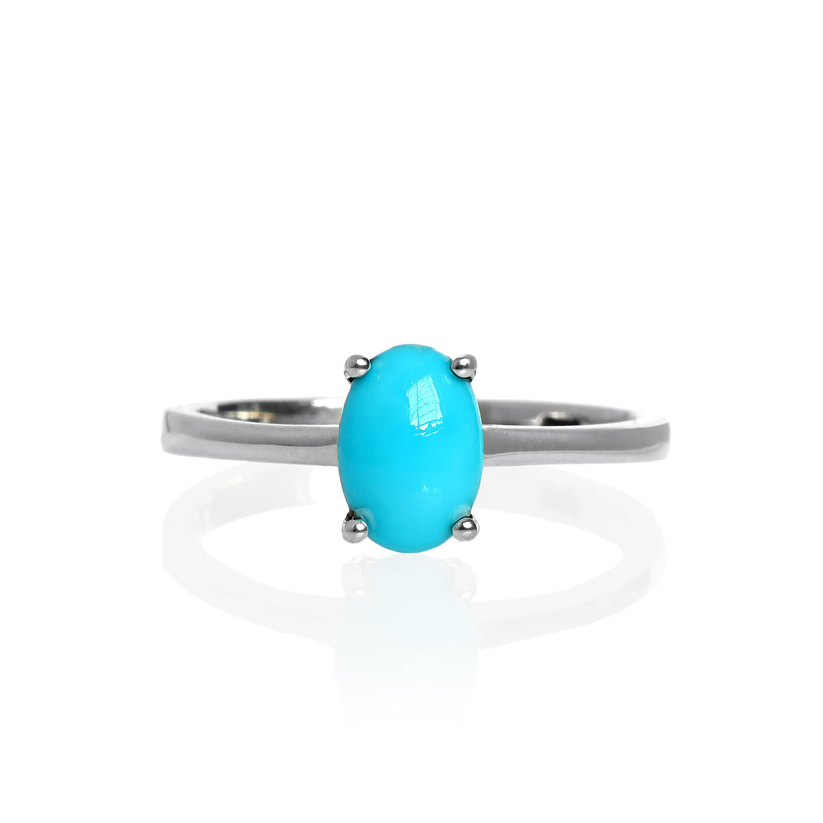 A product photo of an oval 925 sterling silver solitaire ring on a white background. The band is rounded and smooth, and the 7x5mm Sleeping Beauty turquoise birthstone is held in place by 4 delicate silver claws.