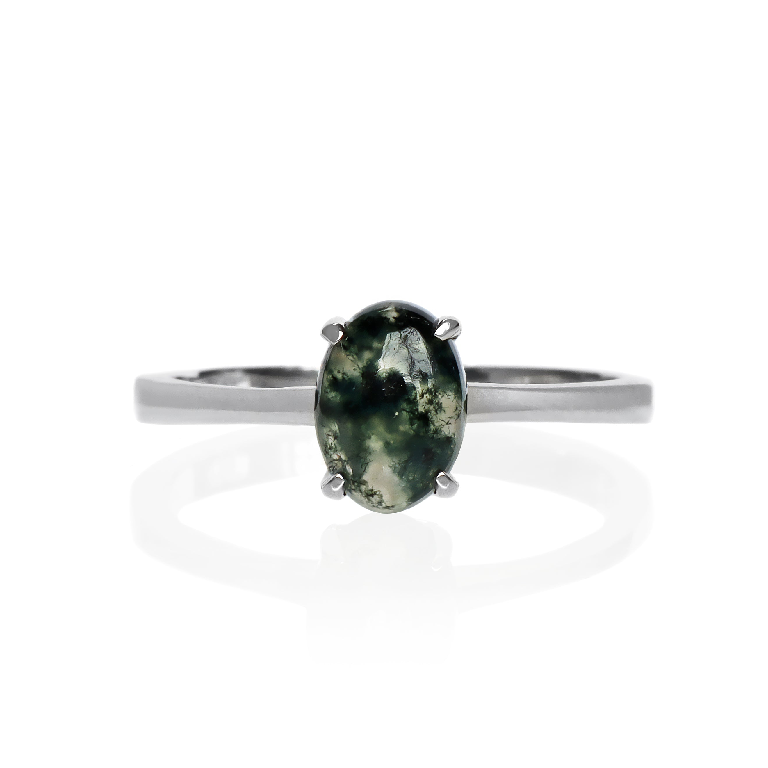 A product photo of an oval 925 sterling silver solitaire ring on a white background. The band is rounded and smooth, and the 7x5mm cabochon moss agate is held in place by 4 delicate silver claws.