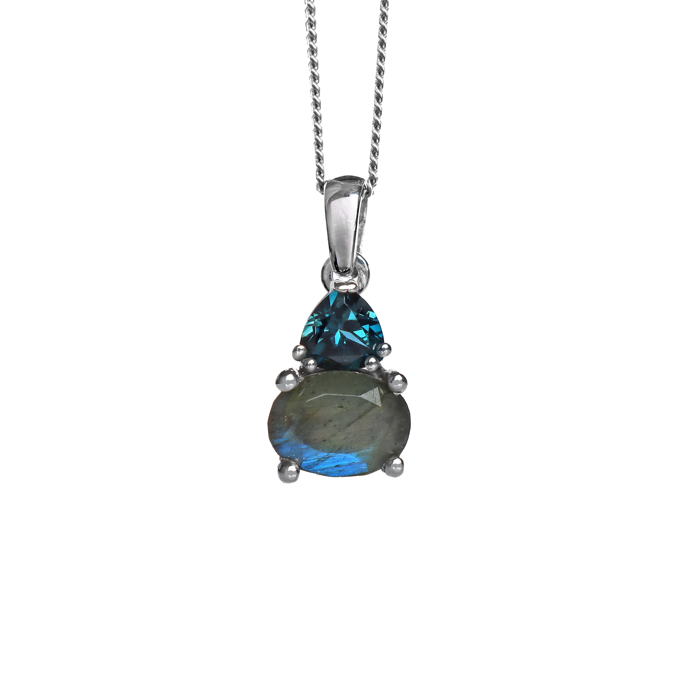 A product photo of a silver labradorite and London Blue Topaz necklace suspended against a white background. The horizontally-oriented labradorite stone is held in place by 4 pairs of claws at its top and bottom, with a 5mm London Blue Topaz gem connecting the stone to the rest of the pendant. It is suspended by a simple silver chain.