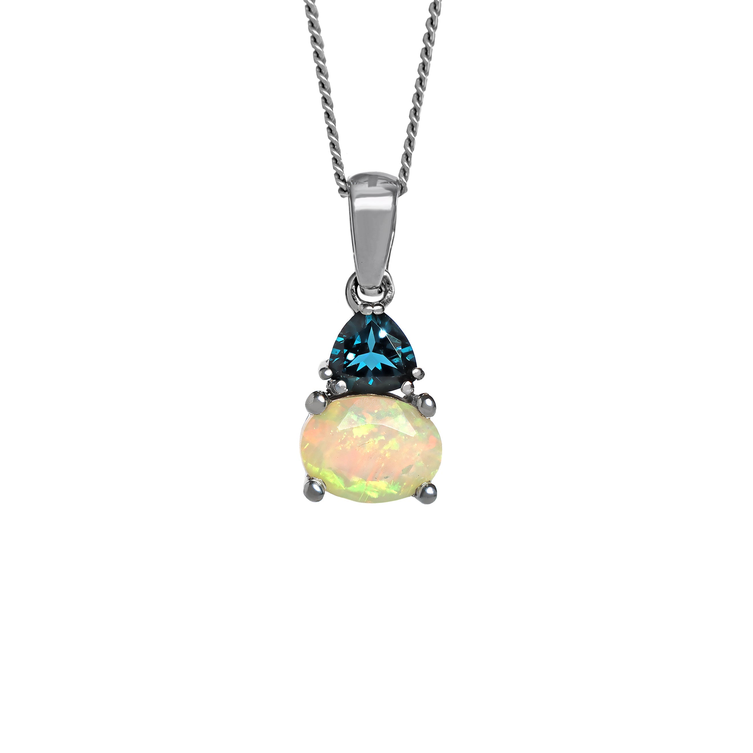 A product photo of a silver Ethiopian rainbow opal and London Blue Topaz necklace suspended against a white background. The horizontally-oriented Ethiopian rainbow opal stone is held in place by 4 pairs of claws at its top and bottom, with a 5mm London Blue Topaz gem connecting the stone to the rest of the pendant. It is suspended by a simple silver chain.