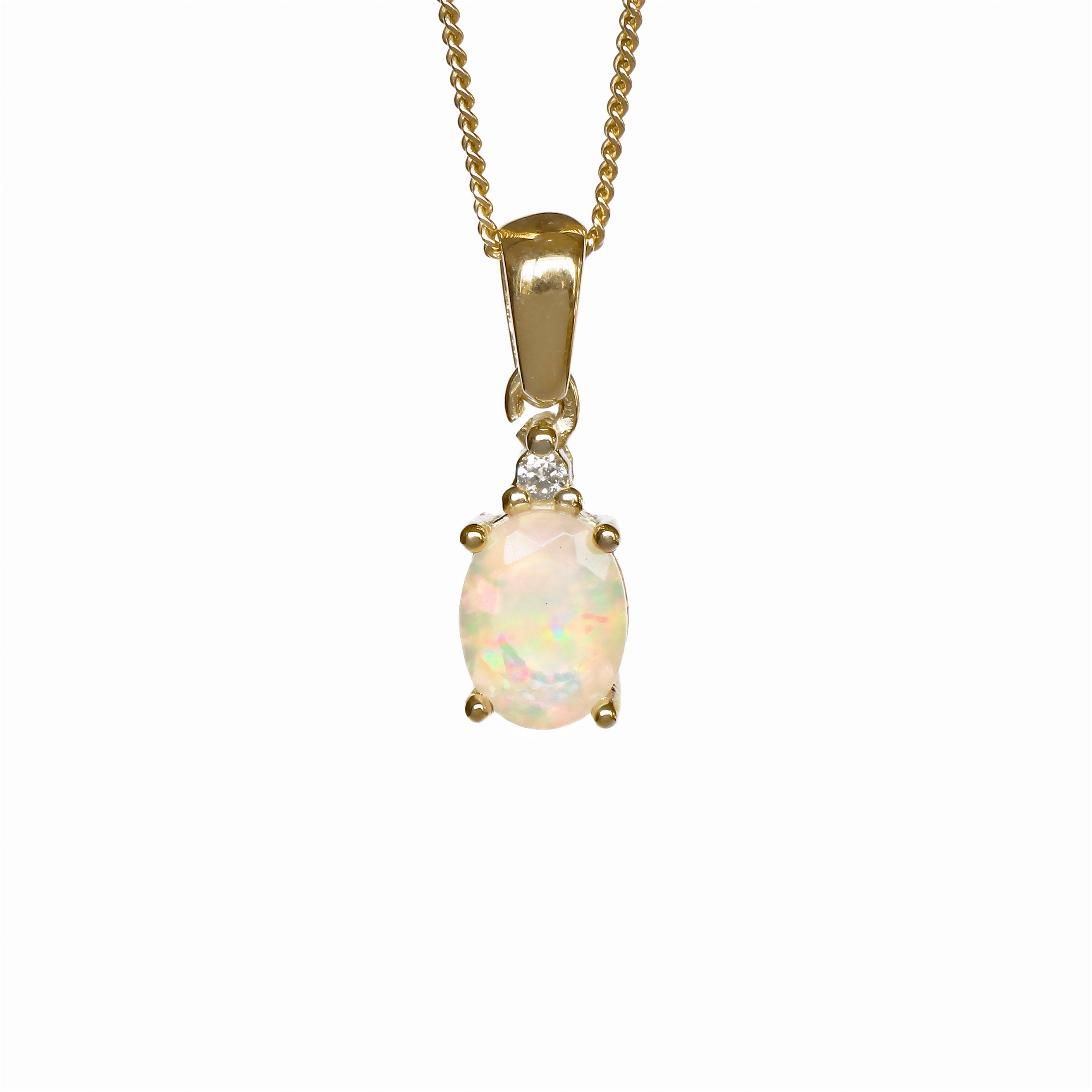 A product photo of a yellow gold hydrophane Ethiopian rainbow opal and diamond necklace sitting against a white background. The beautifully unique rainbow opal stone is held in place by 4 pairs of claws at its top and bottom, with a trio pf delicate white diamonds connecting the stone to the rest of the pendant. It is suspended by a simple yellow gold chain.