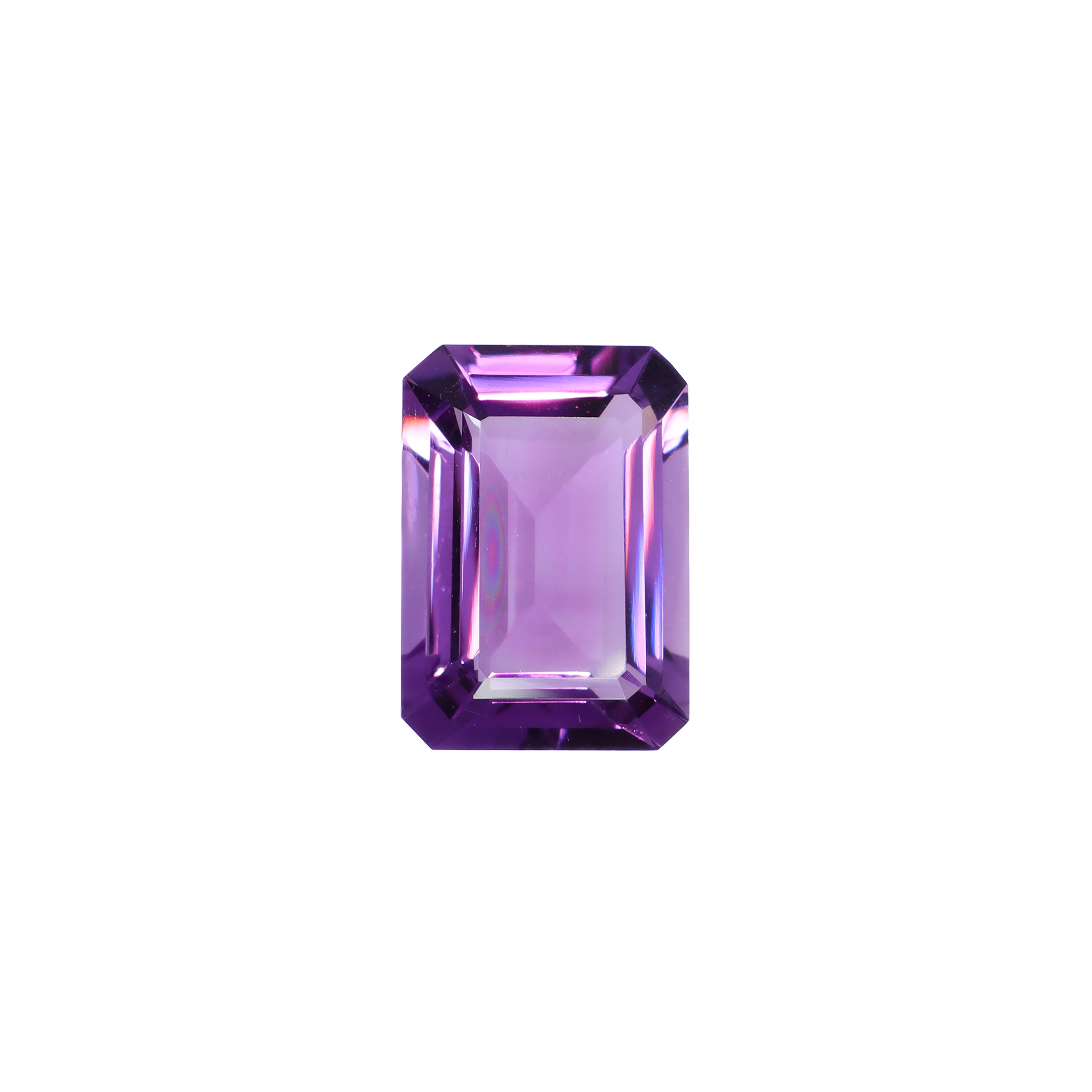 A stunning 14x10mm emerald cut dark purple amethyst gemstone on a white background, featuring a rich, natural vibrant royal purple hue. This beautifully-faceted amethyst pear, also known as the February birthstone, is ideal for bespoke jewellery design, or as a gift to those with a February birthday.