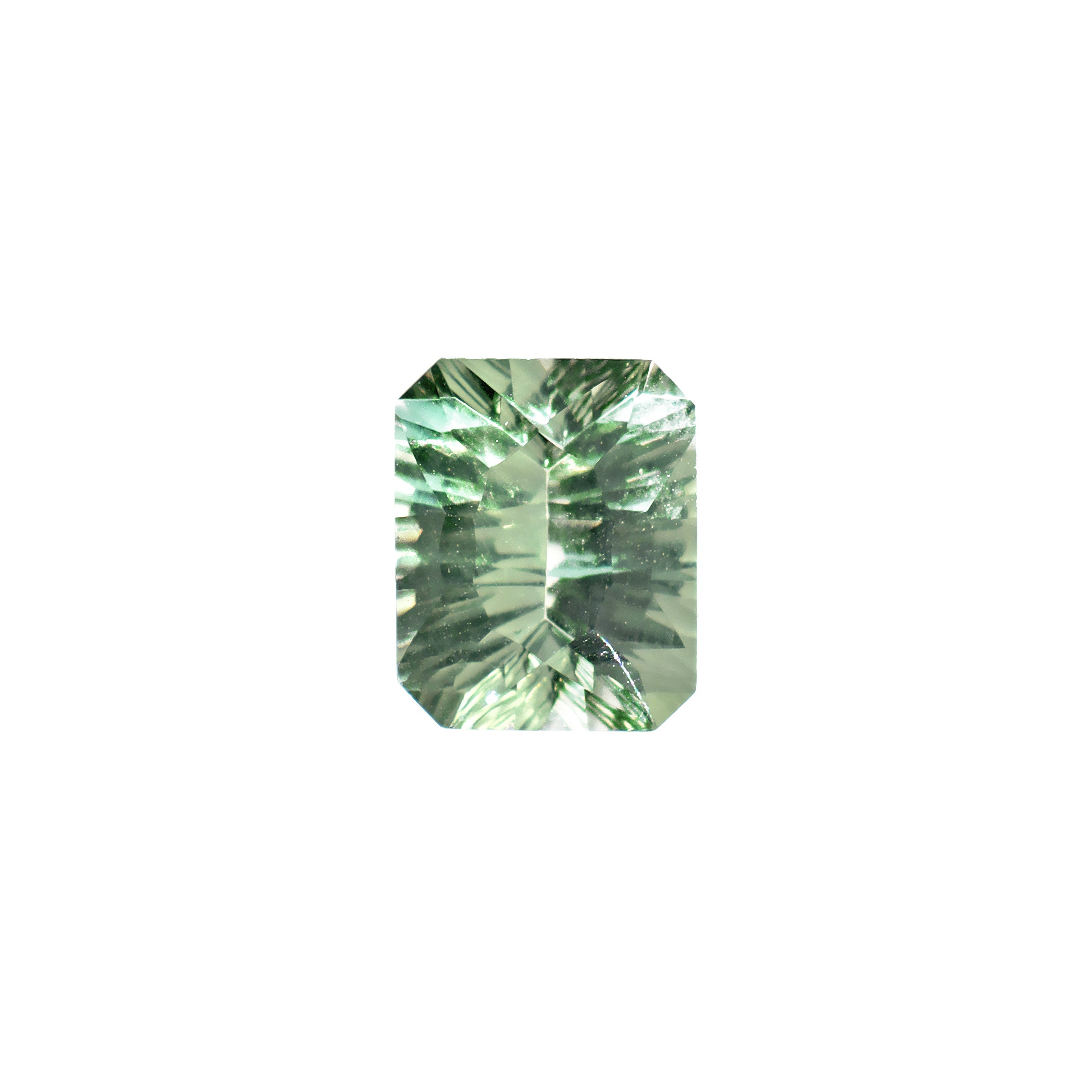 An elegant 10x8mm laser-cut octagonal green amethyst gemstone on a white background. The stone is intricately cut with modern laser tech, giving it a striking, geometric pattern and exceptional internal brilliance. The facets create multiple, sharp light reflections, making the stone appear highly sparkly and dynamic, showcasing its unusual mint green colouring. Perfect for a February birthday gift.