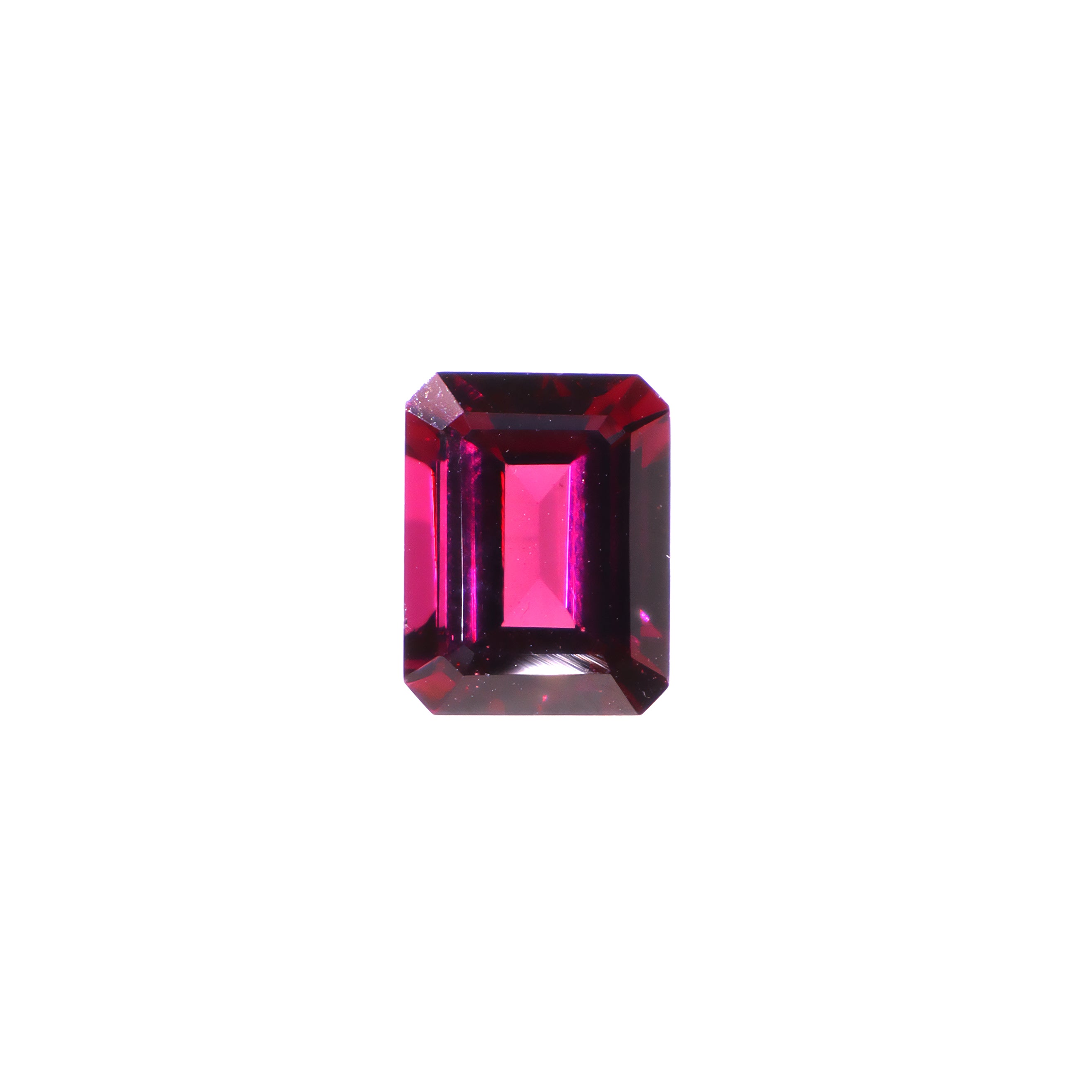 A loose 9x7mm octagonal cut grape garnet gemstone on a white background. This brilliant, richly coloured grape garnet, a variant of January's birthstone, is perfect for creating custom fine jewellery: including engagement rings, cocktail rings, or a striking birthstone pendant for a loved one born in January. The size is large, but small enough for use in everyday wearable jewellery - and is not limited to statement designs.