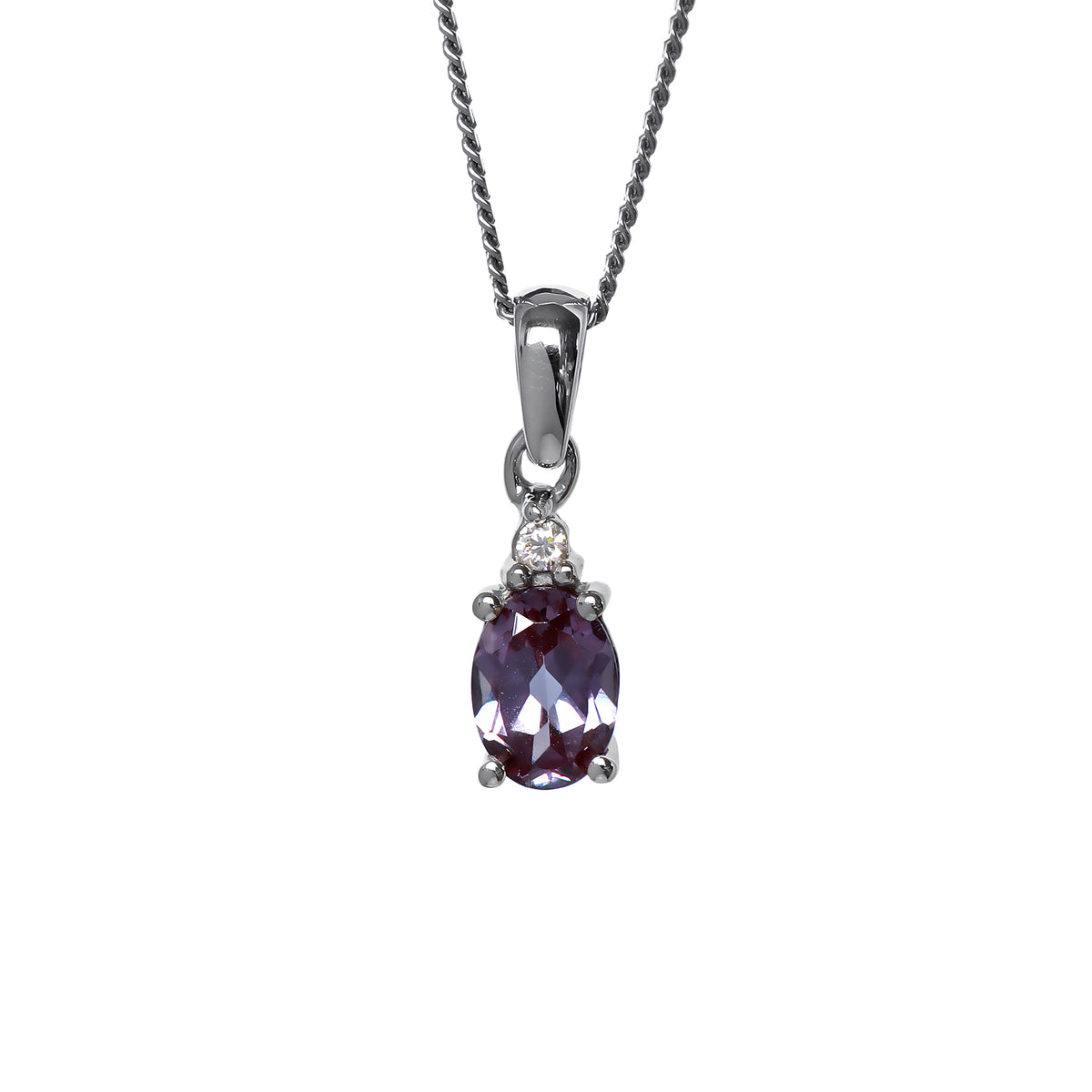 A product photo of a sterling silver lab alexandrite and moissanite necklace sitting against a white background. The beautifully unique lab alexandrite stone is held in place by 4 pairs of claws at its top and bottom, with a single white moissanites connecting the stone to the rest of the pendant. It is suspended by a simple sterling silver chain.
