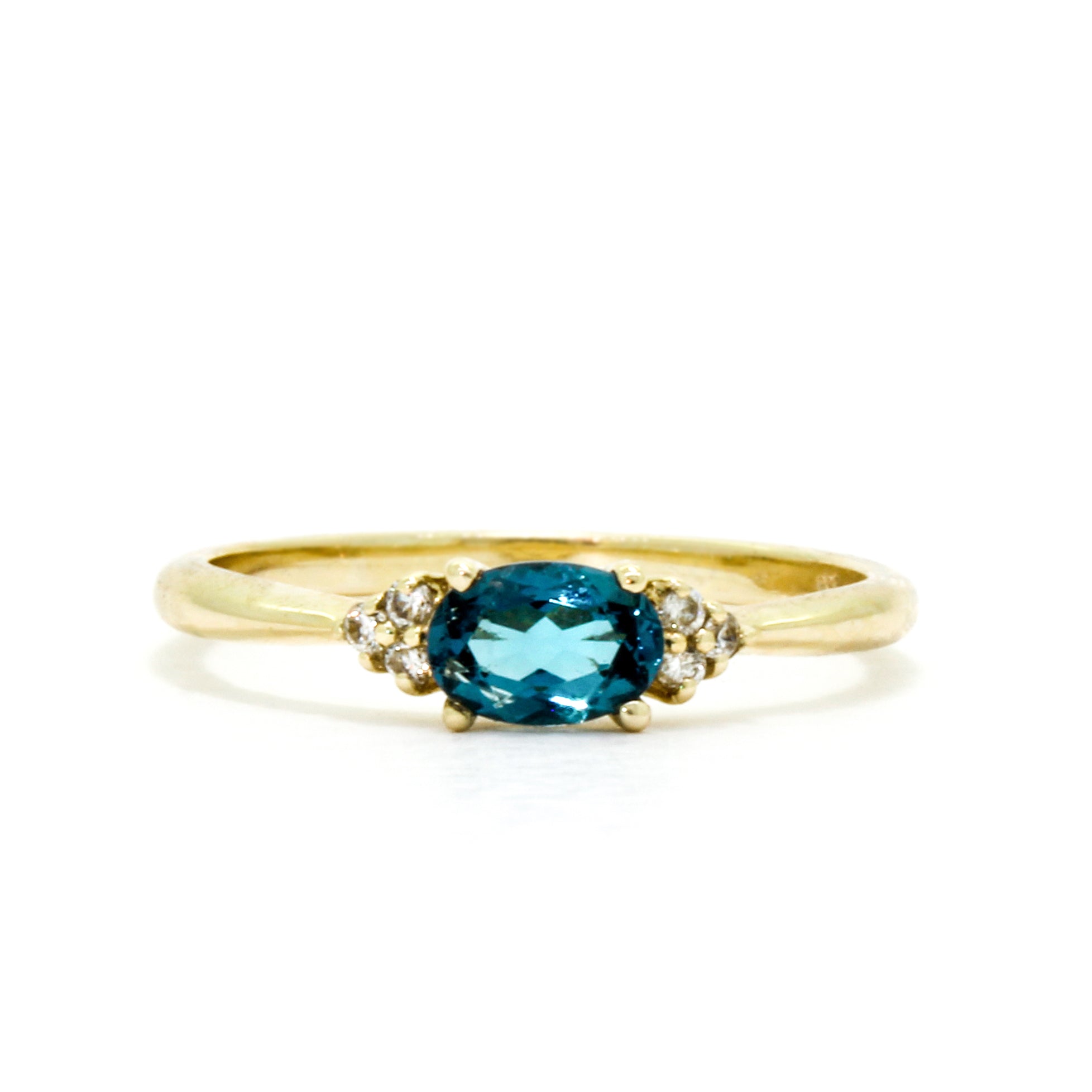A dainty and elegant golden ring with a stunning combination of topaz and diamond detailing.