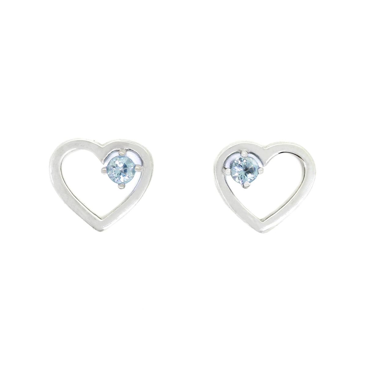 A product photo of two silver heart-shaped stud earrings sitting on a white background. A delicate, 2.5mm round aquamarine stone is nestled in the top right corner of each heart-shaped frame.