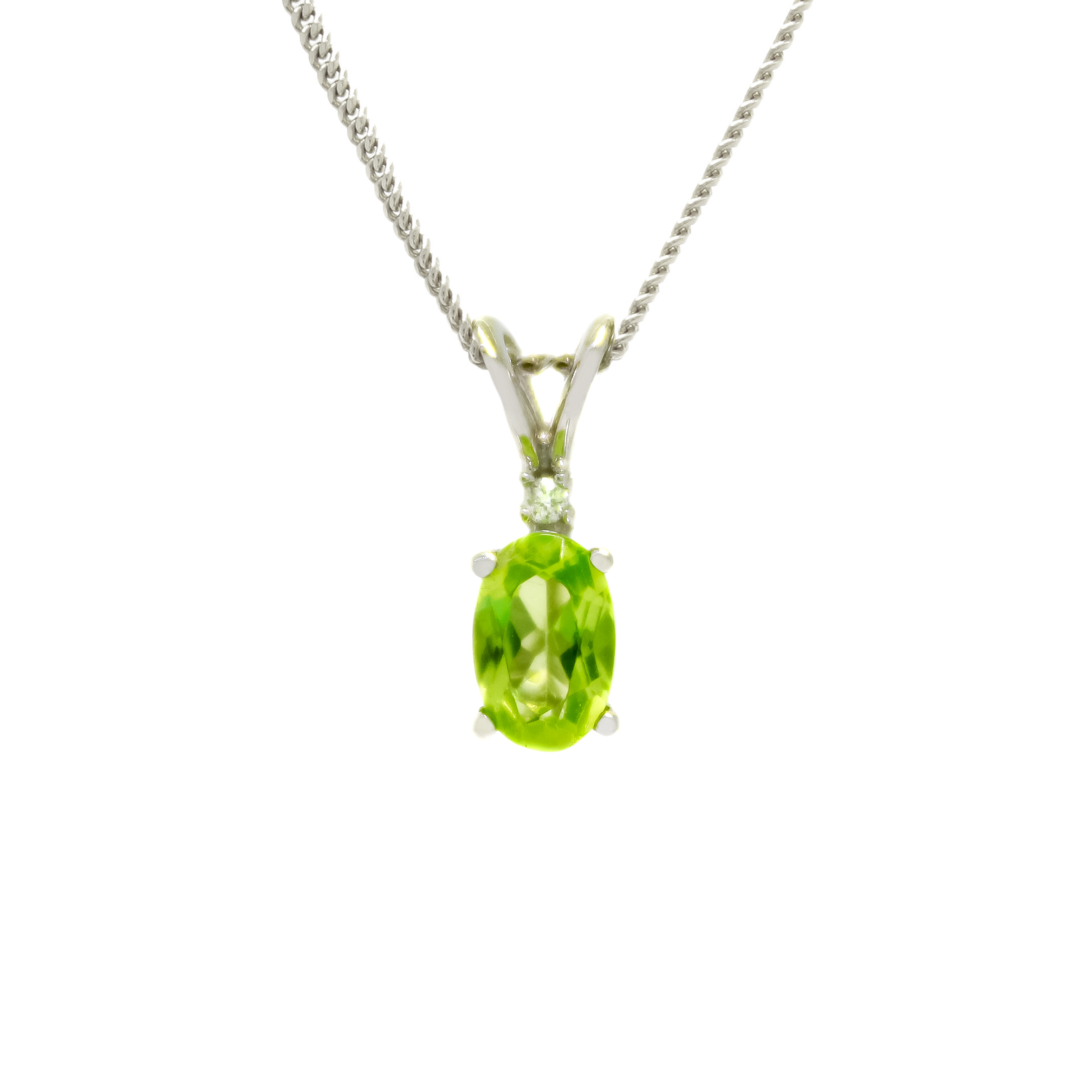 A product photo of an oval peridot and diamond pendant in 9ct white gold suspended against a white background. The oval green gemstone is a stunningly bright grass green colour. A single white diamond sits atop it, before meeting the split golden bail.