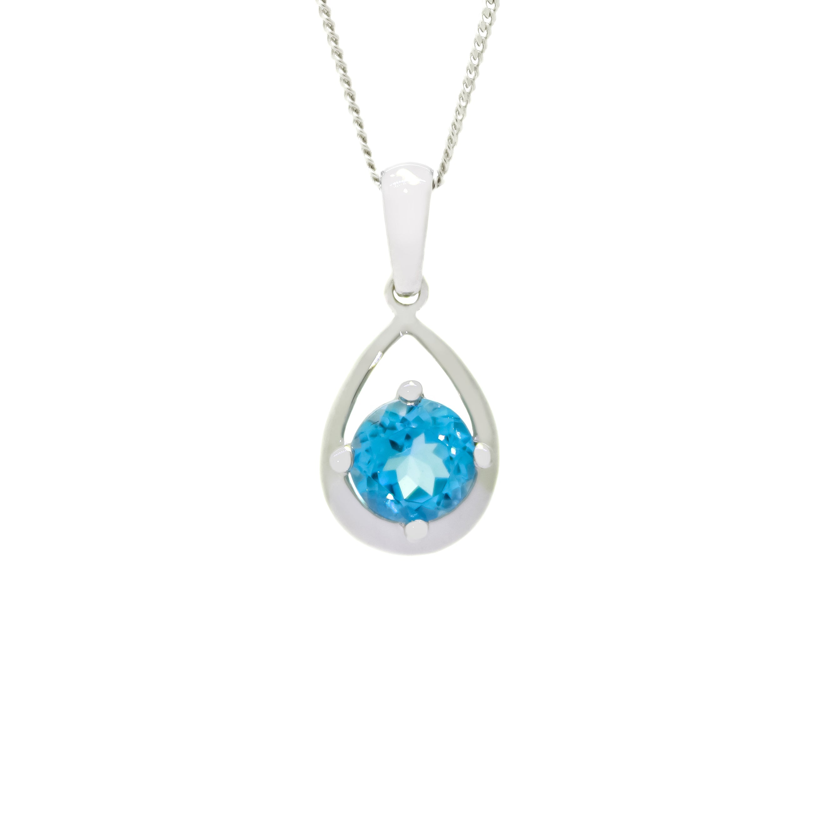 A product photo of a white gold blue toapz necklace suspended against a white background. The bright blue topaz stone, held in place by 4 claws, sits at the bottom of a thick, teardrop-shaped frame of white gold.