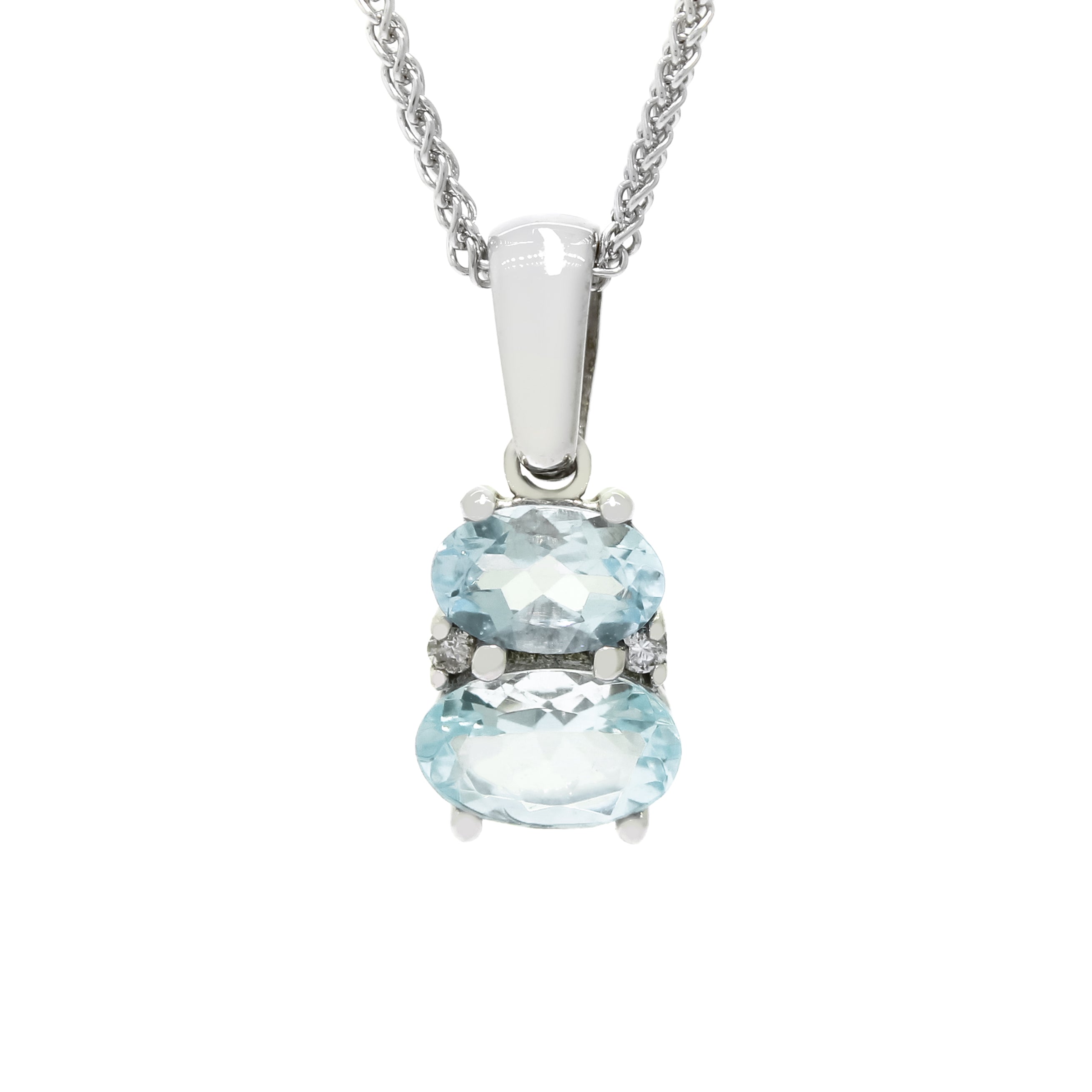 A product photo of an aquamarine and diamond pendant in 9k white gold sitting on a white background. The pendant is made up of two horizontal oval-shaped blue aquamarine stones, the bottom one being 7x5mm and the top being 6x4mm. The spaces between the two stones are filled with one small diamond on either side.