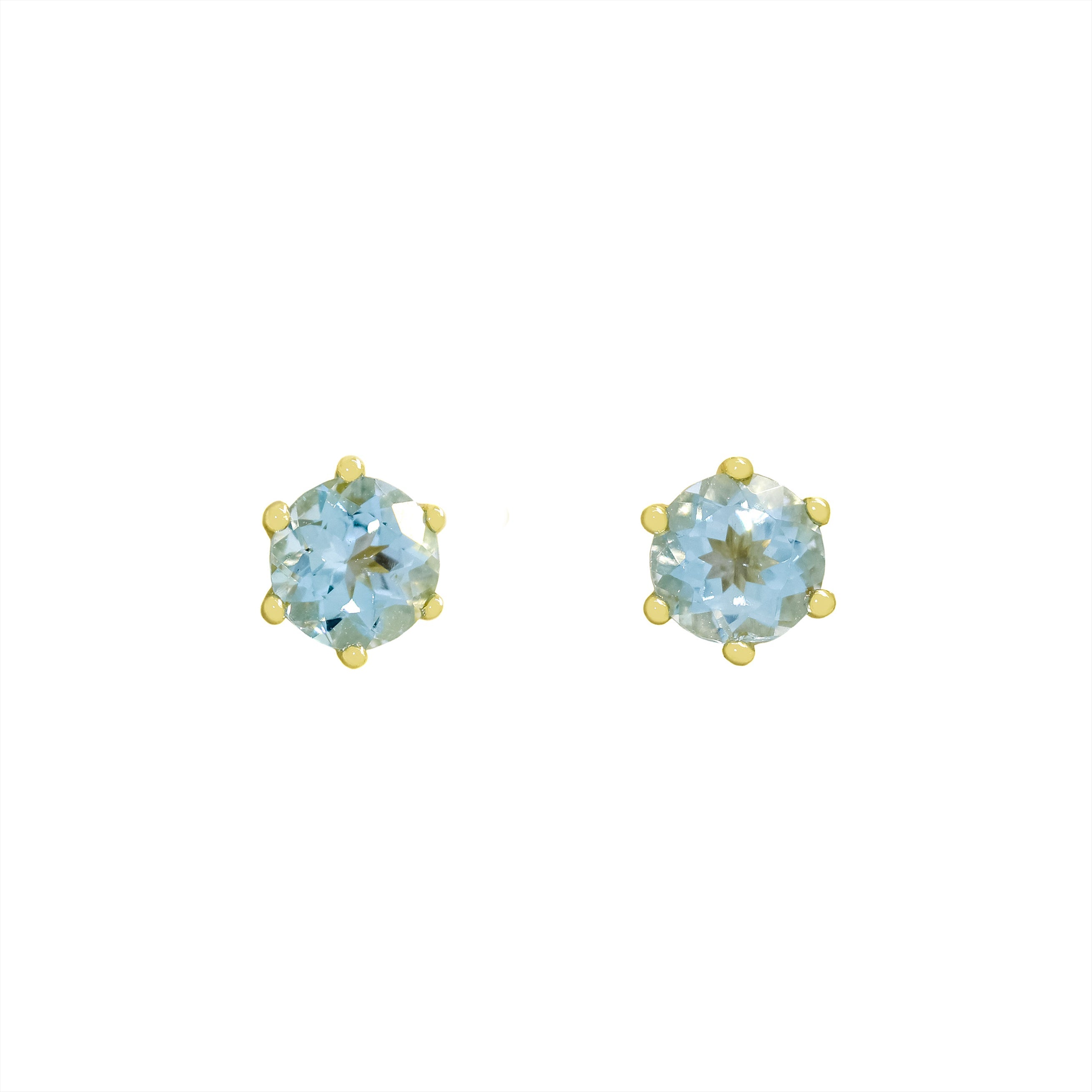 A product photo of two yellow gold stud earrings sitting on a white background. Held in place by 6 golden claws each are two dazzling round-cut aquamarine gemstones, reflecting shades of baby blue light from their many edges.