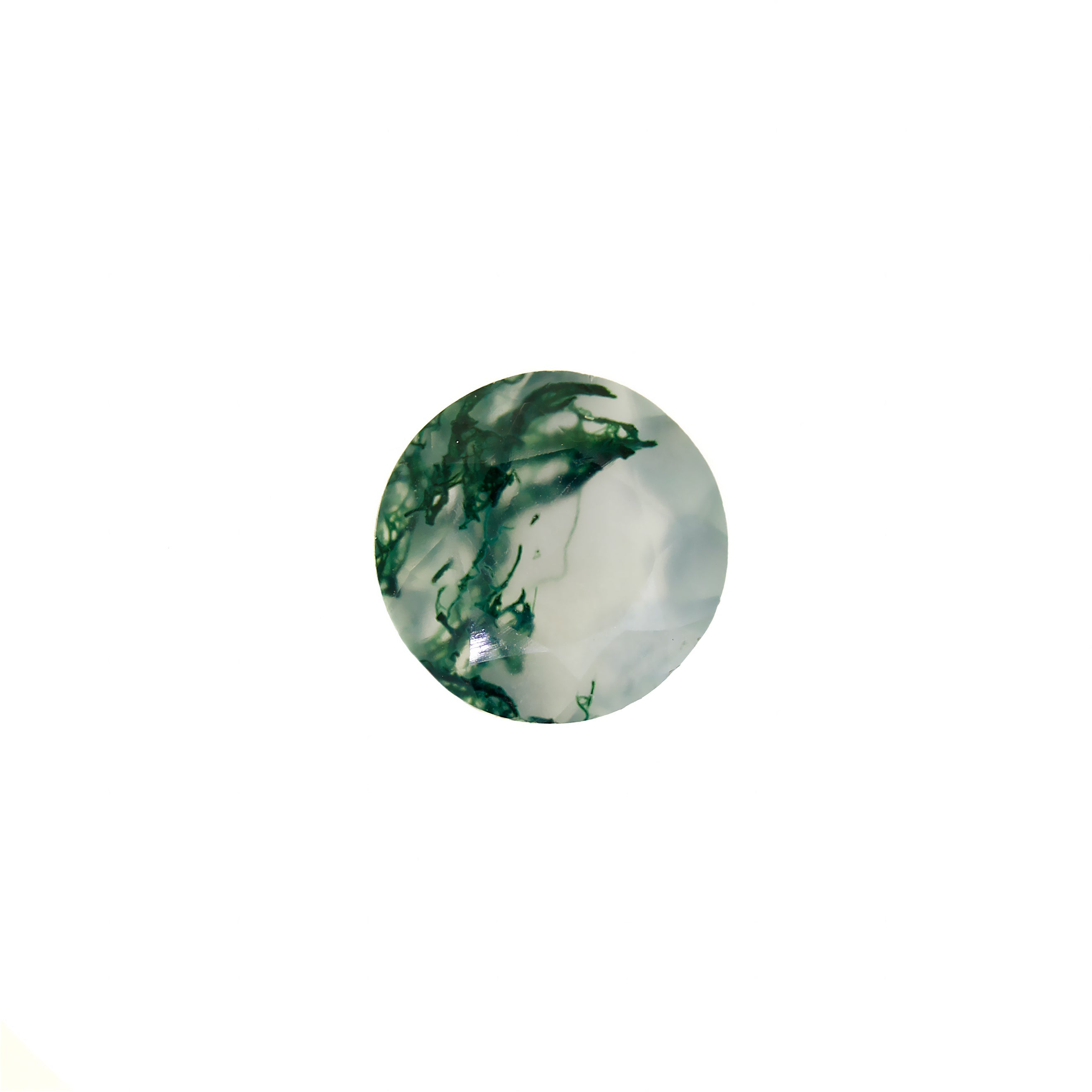 A product image of a loose 8mm faceted round-cut moss agate stone. The stone has a cool white milky colour, with deep, swirling green natural inclusions - appearing as moss-like structures or delicate inkspills within the stone. The faceted edges reflect bright white light.