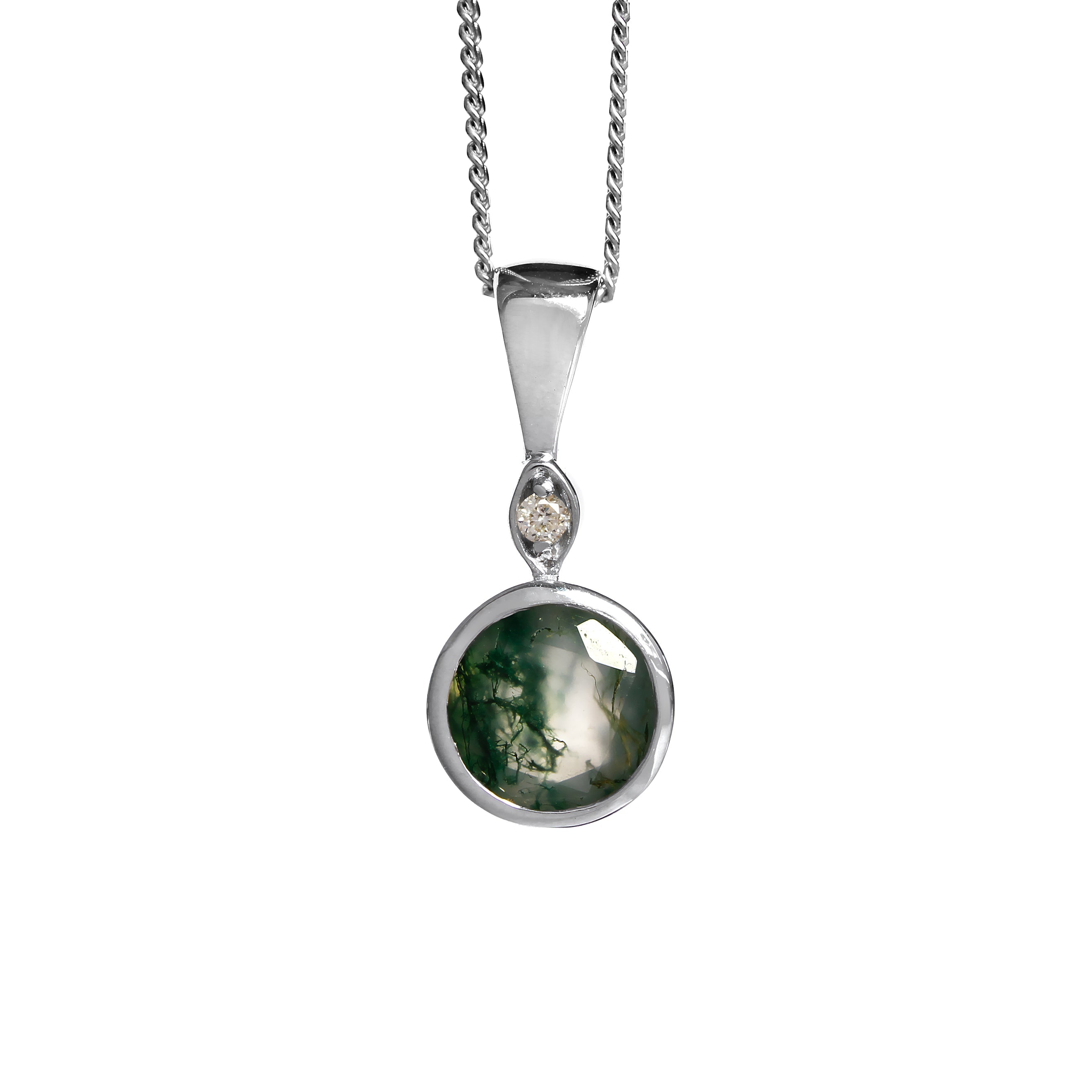 A product photo of a large, 7mm round moss agate and diamond pendant suspended by a 9ct white gold chain over a plain white background. The 7mm round moss agate stone has light semi-opaque base colouring and swirling, dendritic tendrils of deep green inclusions, and is set in a thick white gold bezel setting.