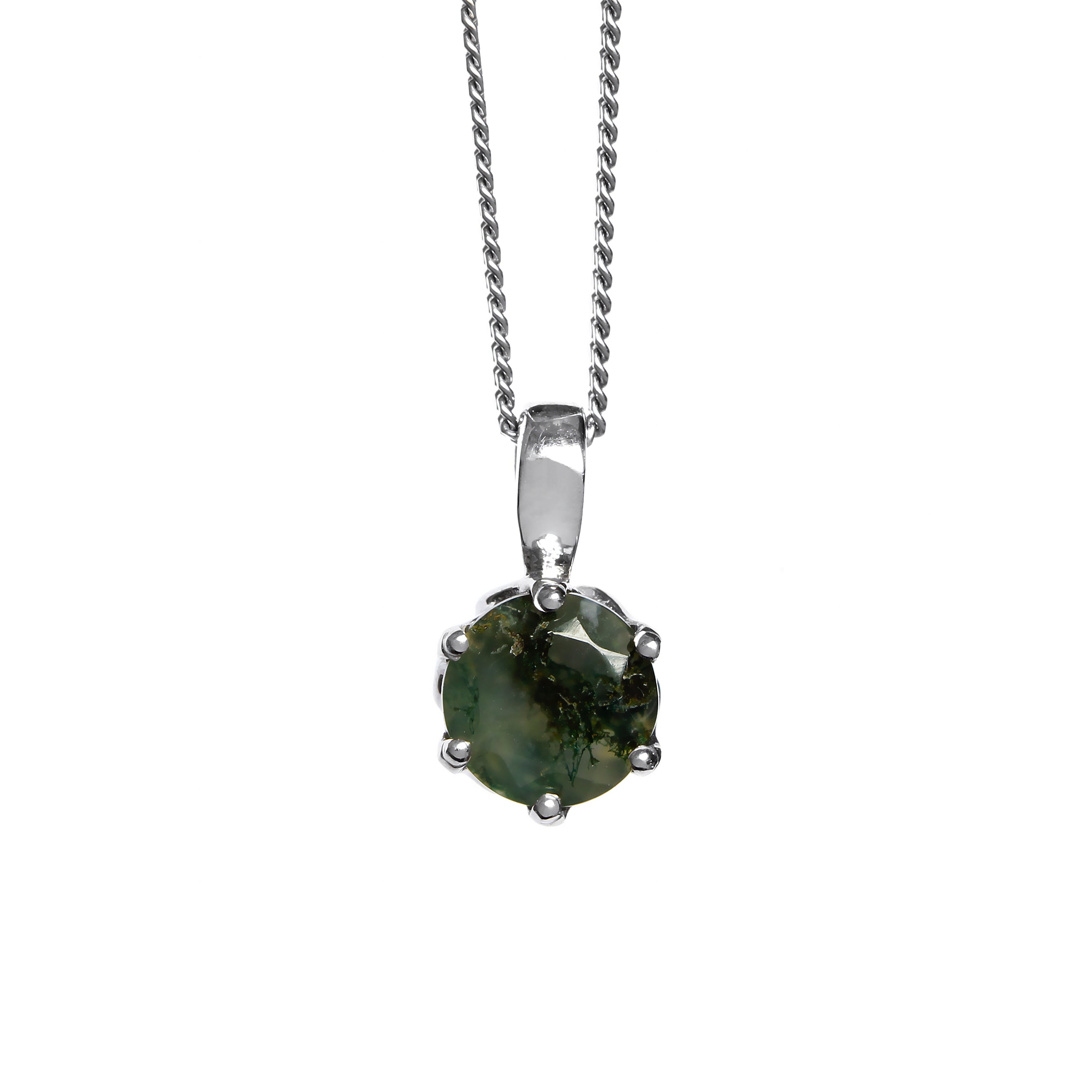 A product photo of a 7mm round moss agate pendant in 9k white gold suspended by a gold chain against a white background. The stone is held in place by 6 delicate golden claws, and is shrouded in the shadow of its heavy floral design. The 7mm round moss agate stone has dark semi-opaque base colouring and swirling, dendritic tendrils of deep green and black inclusions