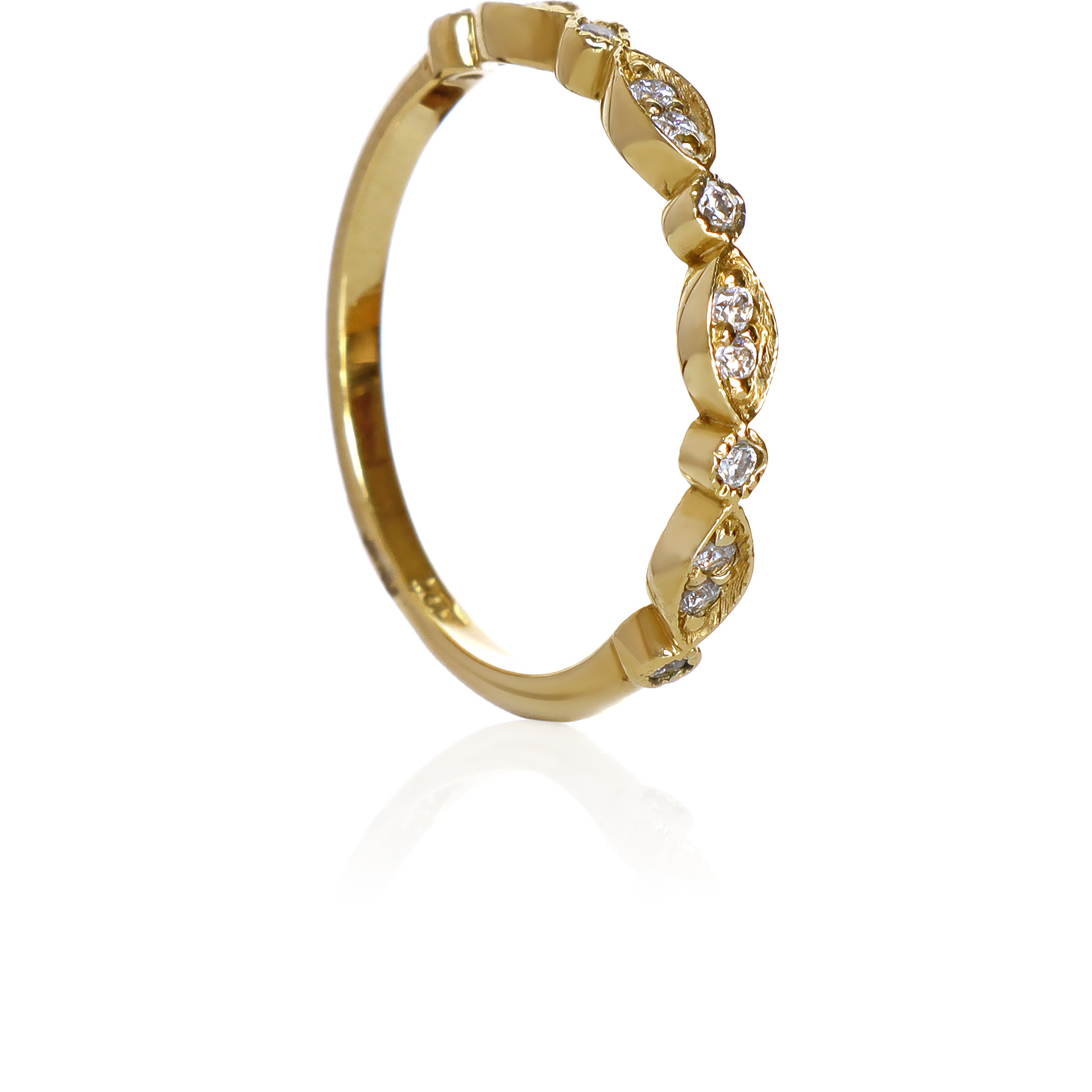 A product photo of an ornate moissanite ring in 9k yellow gold. Oval gold frames adorned with two small moissanite gems each alternate with circular gold frames adorned with singular moissanite gems and make up the ring for about half of its length before smoothing out into a simple rounded yellow gold band.