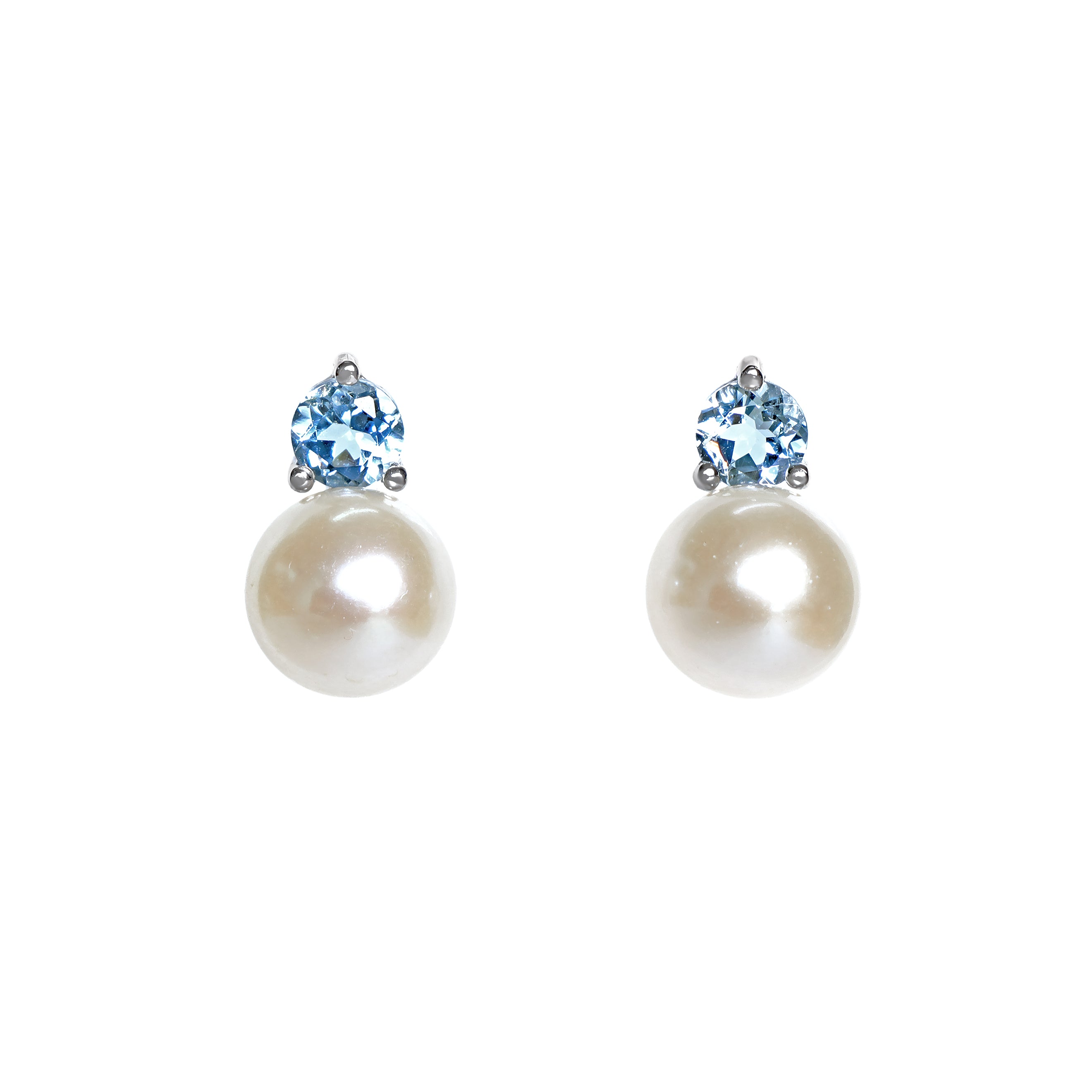 A product photo of delicate white pearl earring studs on a white background. The white pearls each have aquamarine detailing above them connecting to the white gold studs.