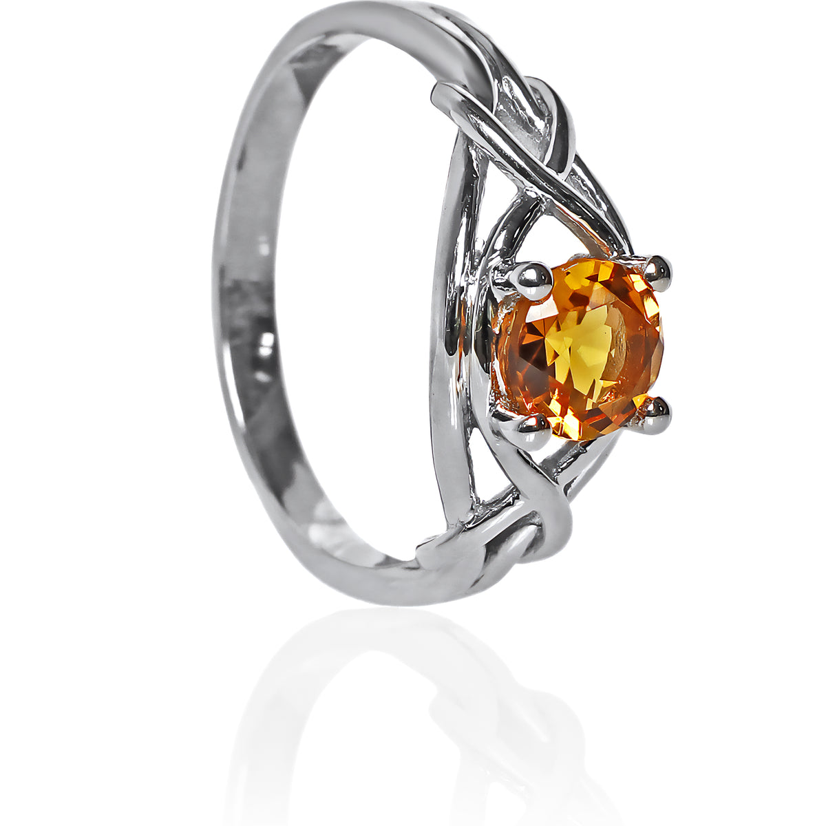 A product photo of an ornate silver ring with a circle-cut citrine centre stone sitting on a white background. The back of the silver band is simple and smooth, before splitting into four serpentine tendrils on either side that delicately coil around one another before meeting on either side of the circle-cut centre stone, which is held in place by four small silver claws. The citrine jewel is almost honey-coloured, reflecting a bright orangey yellow colour across its multi-faceted surface.