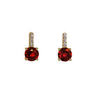 A product photo of 5mm Round Garnet & Diamond Earrings in 9k Yellow Gold sitting on a plain white background. A golden strip connects the garnets to the studs, each strip adorned with 3 diamonds each. The garnets reflect sanguine hues across their multi-faceted edges.