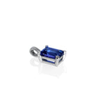 A product photo of a white gold tanzanite pendant suspended by a chain against a white background. The emerald-cut tanzanite stone is held in place by 4 golden claws, and reflects violet blue and indigo colours from its edges.