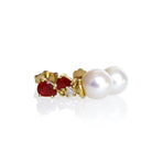 A product photo of a pair of ornate pearl drop stud earrings in yellow gold suspended over a white background. The pearls are creamy white and round, with one small diamond followed by a pear-shaped ruby on each piece linking them to the back of the golden stud.