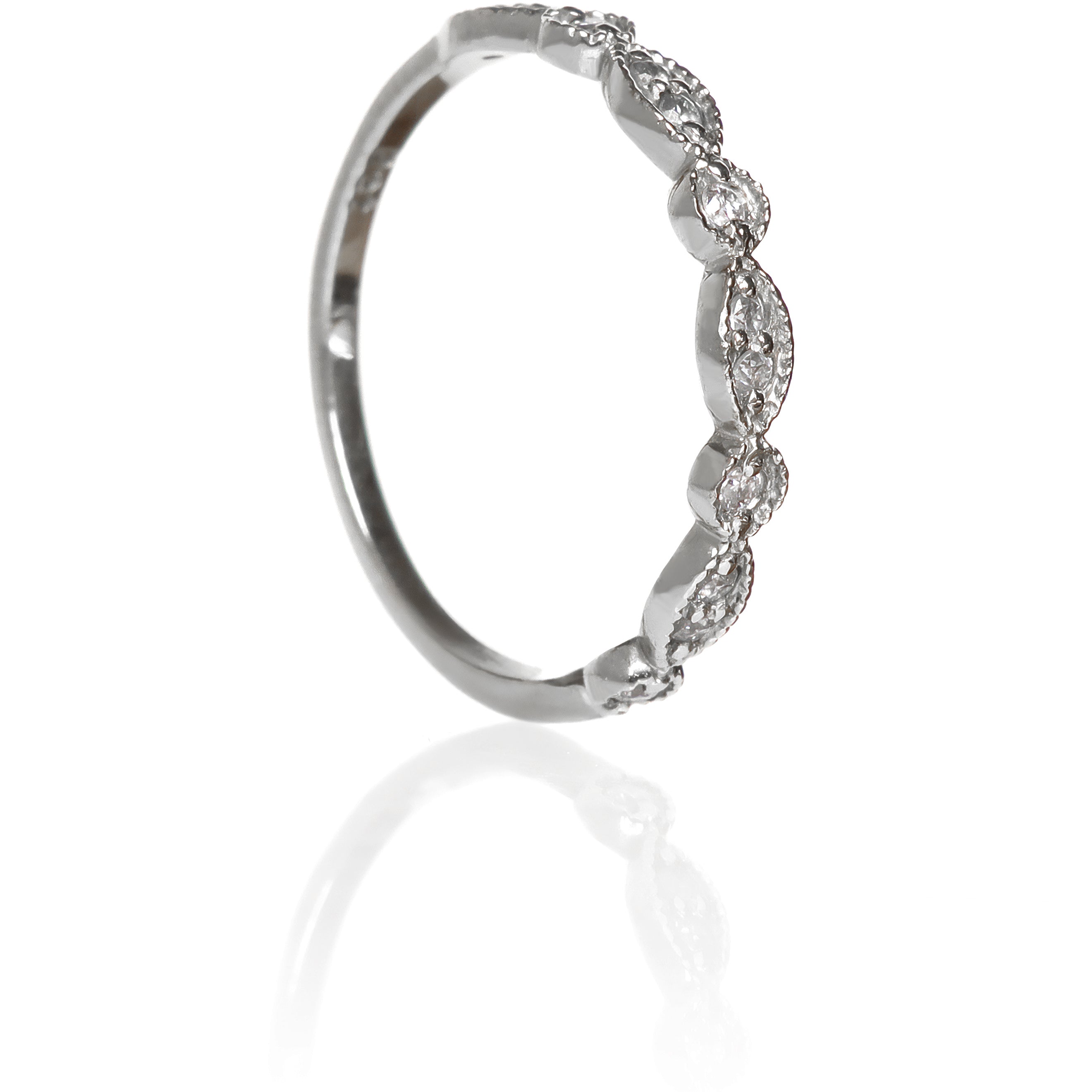 A product photo of an ornate diamond ring in 9k white gold. Oval white gold frames (adorned with two small diamonds each) alternate with circular frames (adorned with a single diamond each), and make up the ring for about half of its length before smoothing out into a simple white gold band.