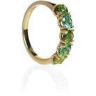 A product photo of a bold, multi-gemstone ring in 9k yellow gold – made up of 5 tourmaline jewels of various shades of green – sitting on a white background. From left to right, 4.5mm round-cut yellow-green, mint, emerald, sea and forest green tourmaline stones make up a bold statement piece
