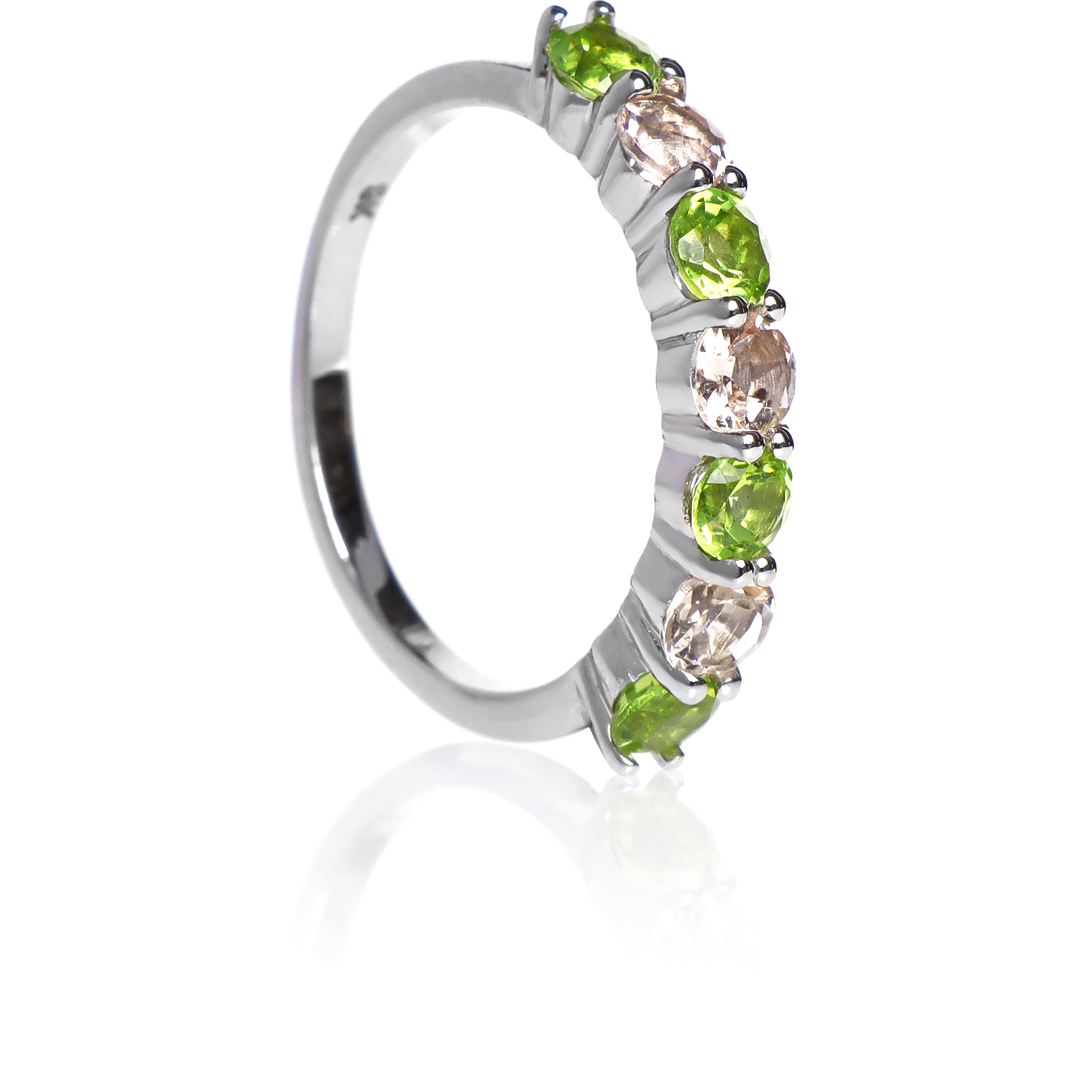 A product photo of a bold, alternating-gemstone ring in 9k white gold – made up of 7 3.5mm peridot and pink morganite stones – sitting on a white background.