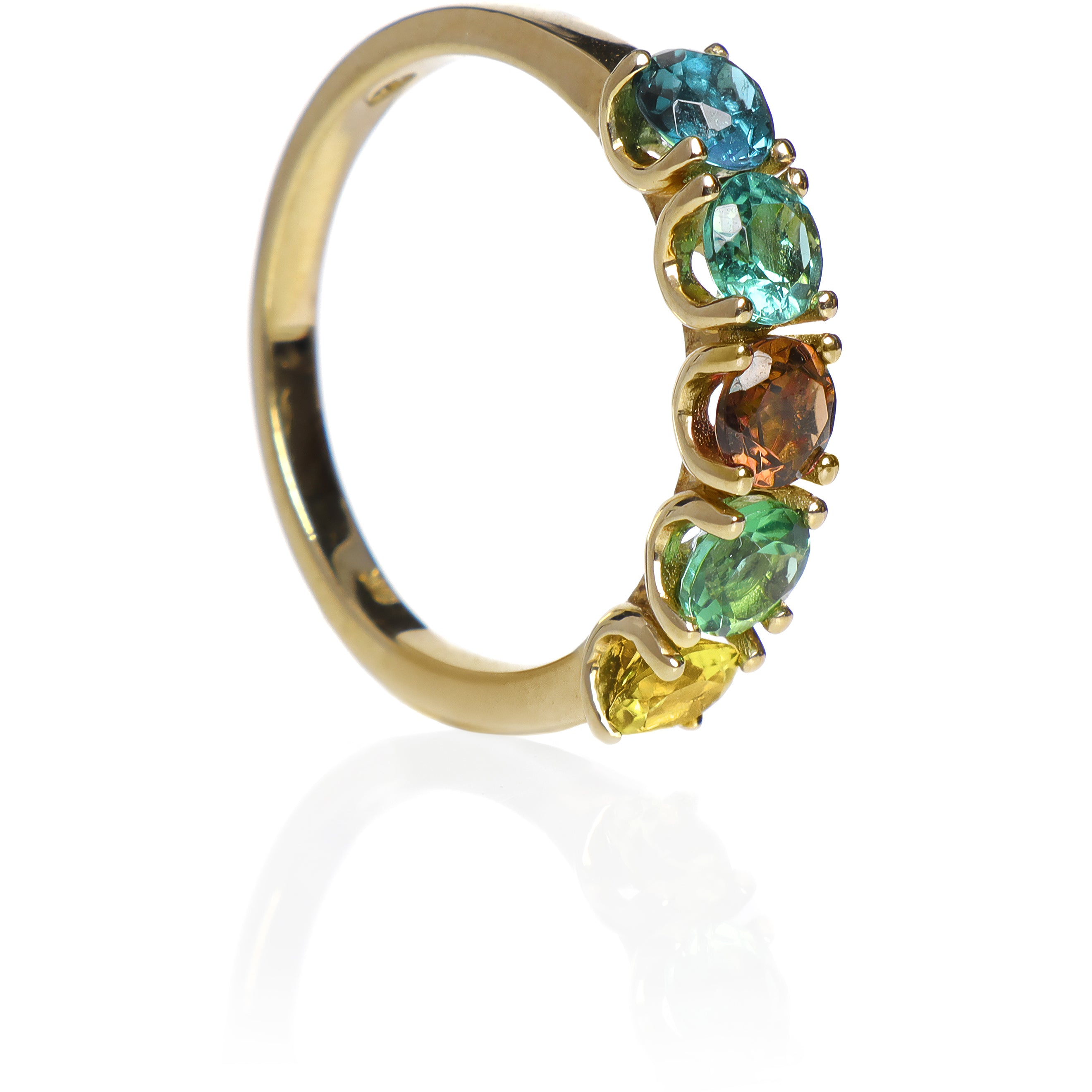 A product photo of a bold, multi-gemstone ring in 9k yellow gold – made up of 5 multi-coloured tourmaline jewels – sitting on a white background. From left to right, 4.5mm round-cut light blue, mint green, orange, pastel green and yellow tourmaline stones make up a bold statement piece.