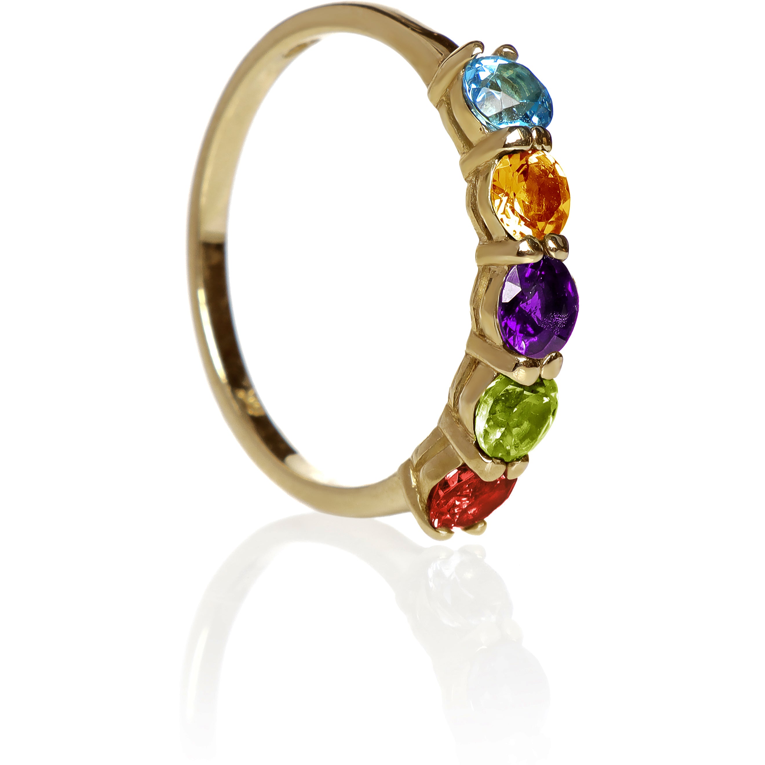 A product photo of a bold, multi-gemstone ring in 9k yellow gold – made up of rainbow-coloured jewels – sitting on a white background.