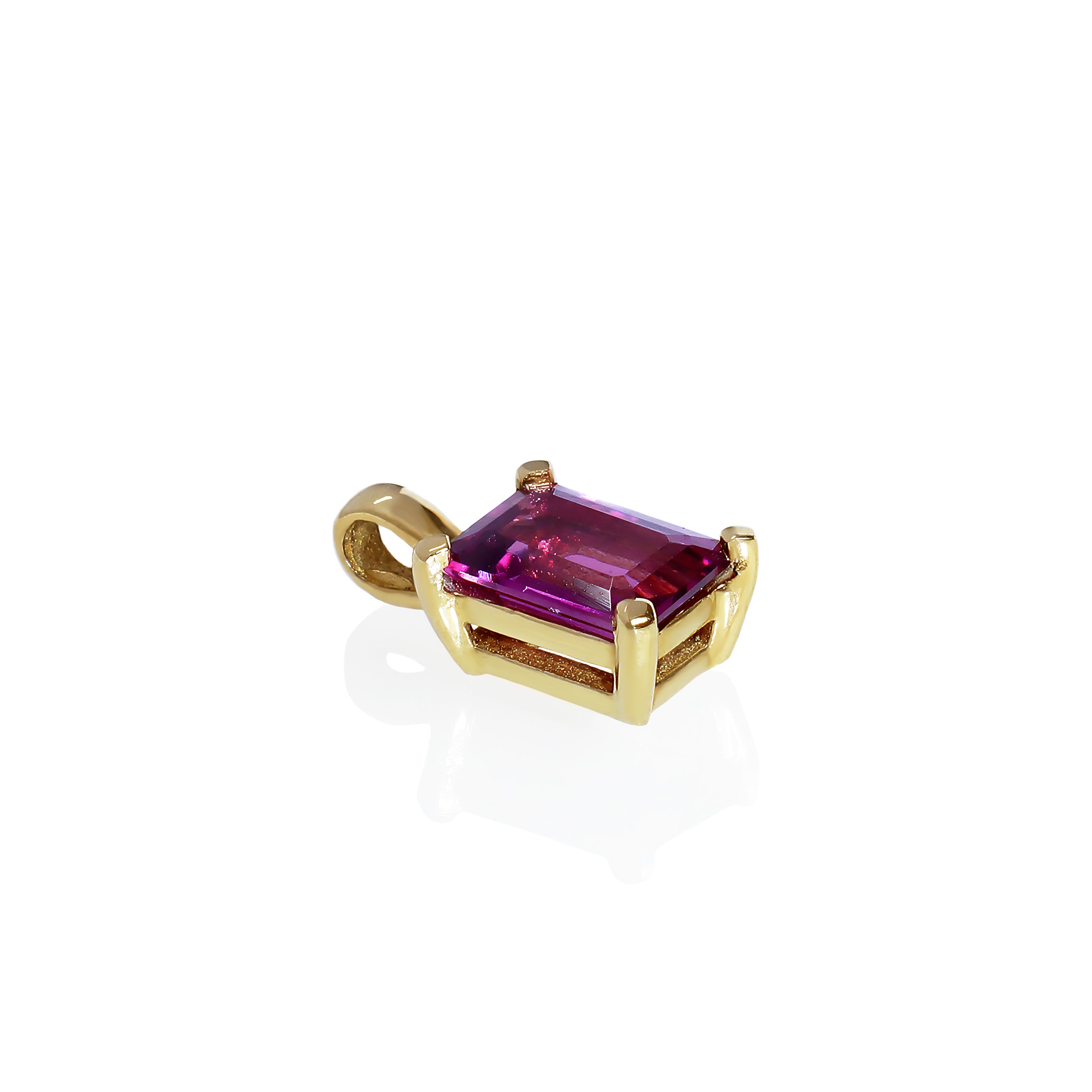 A product photo of a 8x6mm Rectangular Rhodalite Pendant in 9k Yellow Gold suspended against a white background. The impressively large and deeply-coloured stone is contrasted by its overall minimalistic design, 4 simple golden claws holding the gem in place. It is suspended by a simple gold chain. The rhodalite reflects warm, pinky purple hues across its multi-faceted edges.
